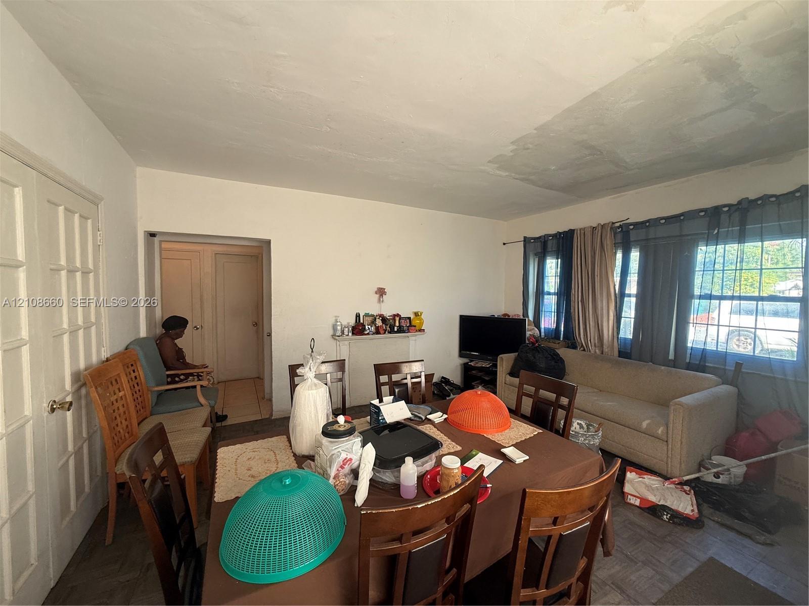 Interior space featuring parquet flooring, a decorative mantel, and multi-pane French doors Interior space featuring parquet flooring, a decorative mantel, and multi-pane French doors