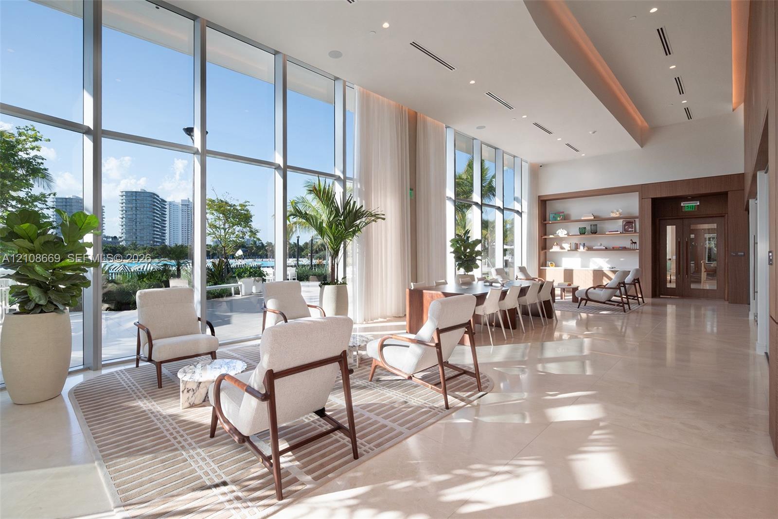 Floor-to-ceiling glass curtain walls, expansive stone flooring, recessed ceiling lighting, built-in recessed shelving, and a coffered ceiling design