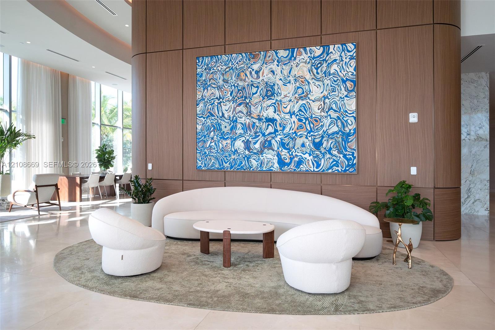 Full-height wood-panel accent wall with curved architectural detailing, floor-to-ceiling glass windows, and polished stone-finish flooring