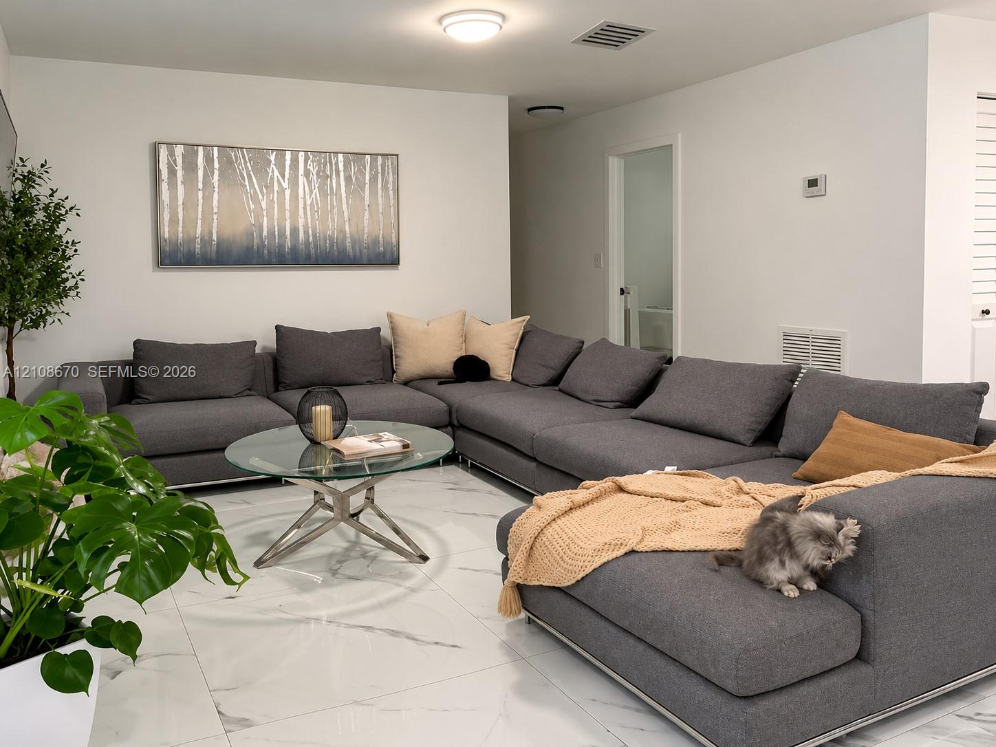 Large-format polished tile flooring with marble-style veining throughout