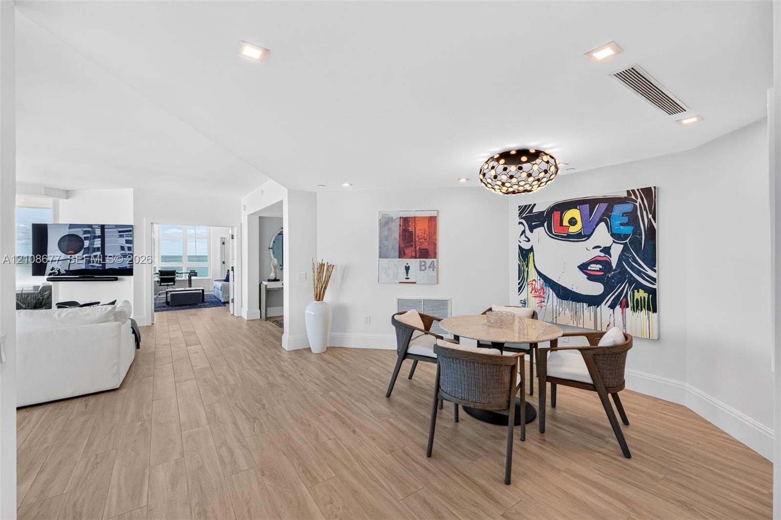 Open-concept dining nook area (can also be a space for an office) featuring porcelain flooring, recessed lighting, and a modern beautiful tiered-orb flush mount fixture (upgraded fire sprinklers & linear HVAC diffusers plus beautiful tall baseboards).