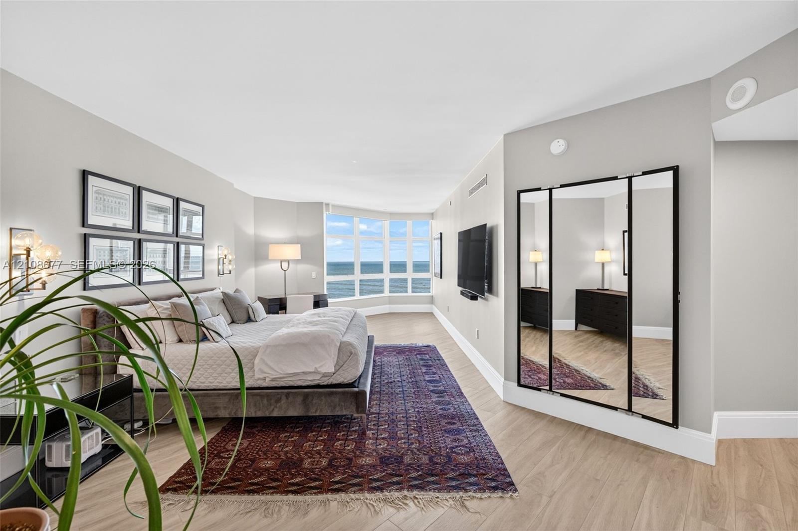 Wood look plank porcelain flooring, floor-to-ceiling bay windows, and a multi-panel mirror dressing area. This is said to be the only unit in the building with a built in primary sitting area (instead of small balcony space). Original developer enclosed the space for first owner. Wood look plank porcelain flooring, floor-to-ceiling bay windows, and a multi-panel mirror dressing area. This is said to be the only unit in the building with a built in primary sitting area (instead of small balcony space). Original developer enclosed the space for first owner.