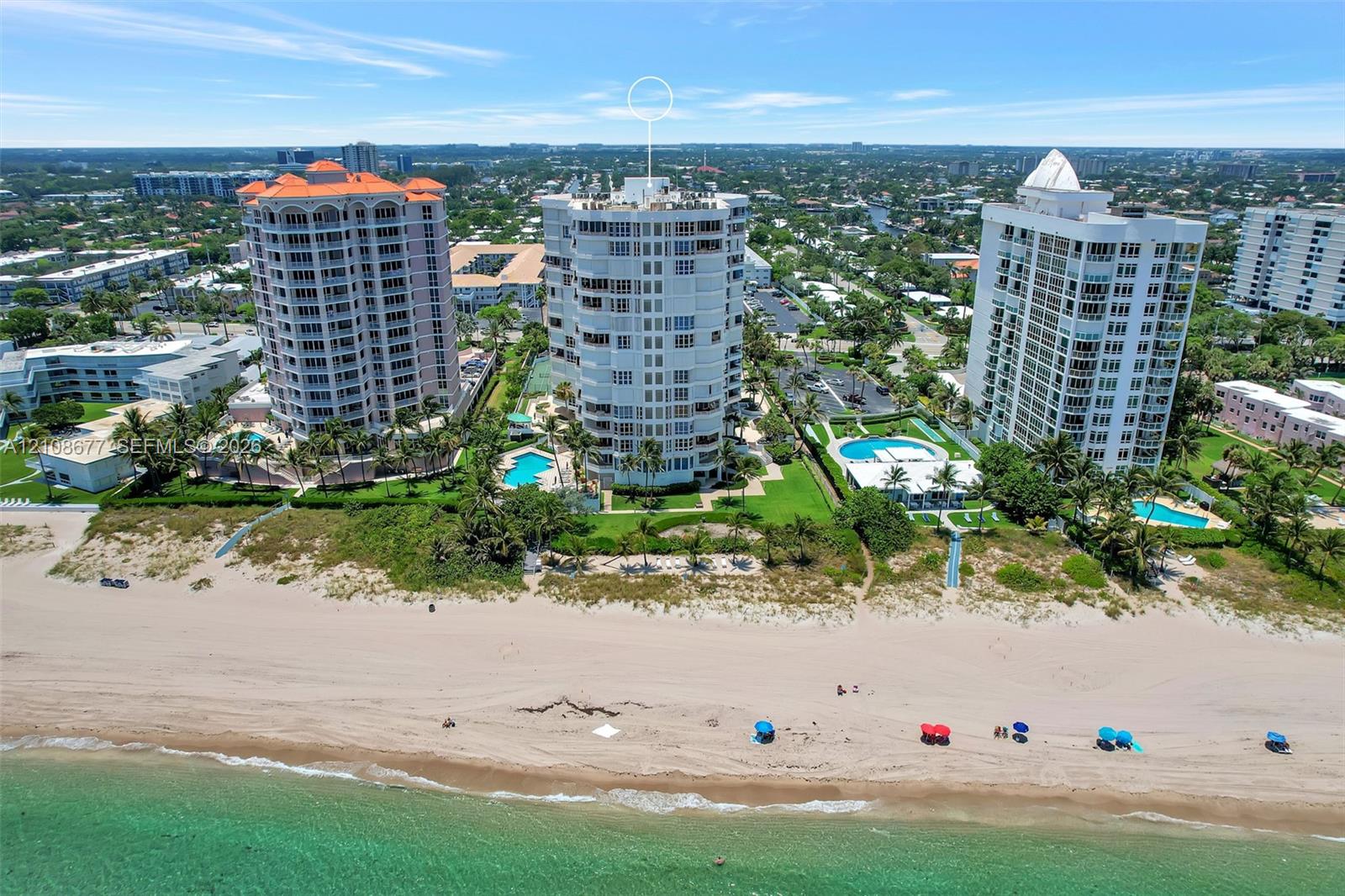 High-rise building featuring direct beachfront access, exterior balconies, and landscaped grounds