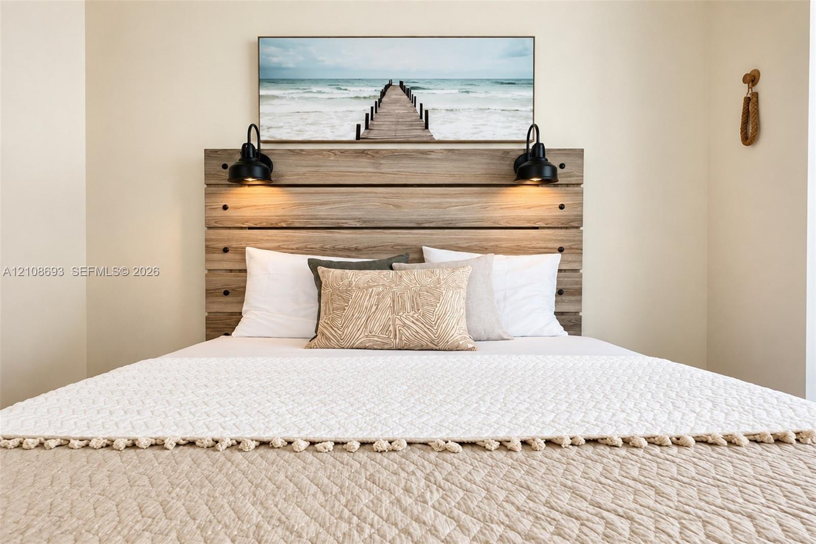 Custom built-in wood-finish headboard featuring matte black hardware and dual wall-mounted matte black sconce lighting