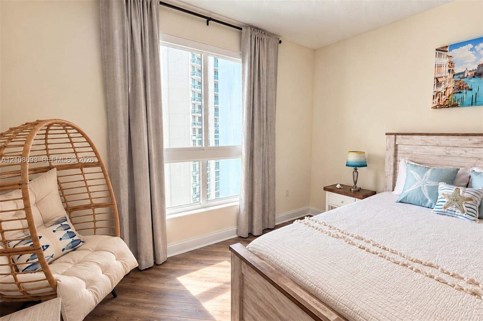 Large window with natural lighting and wood-finish flooring
