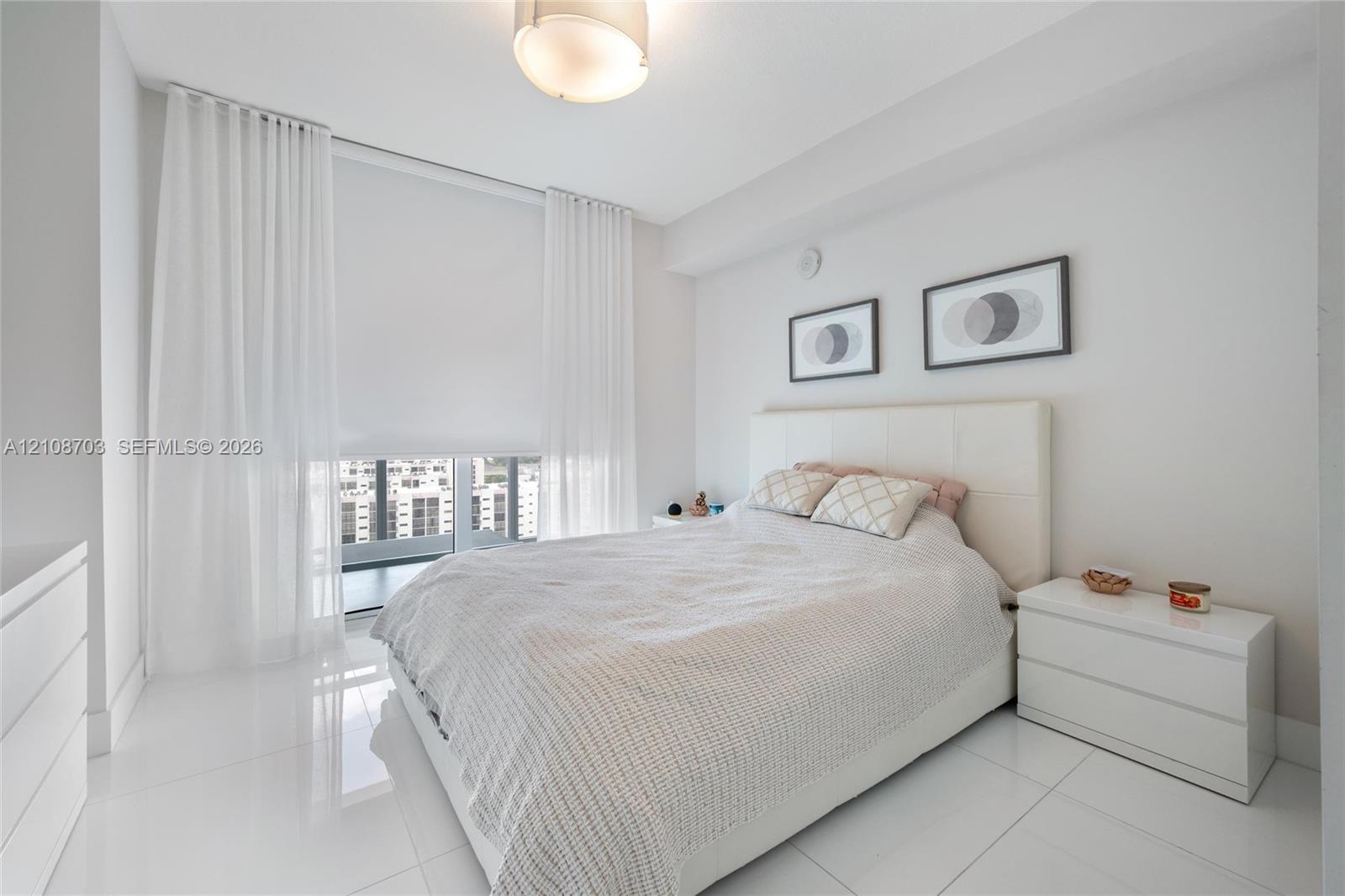 Polished tile flooring, floor-to-ceiling windows, and recessed ceiling lighting