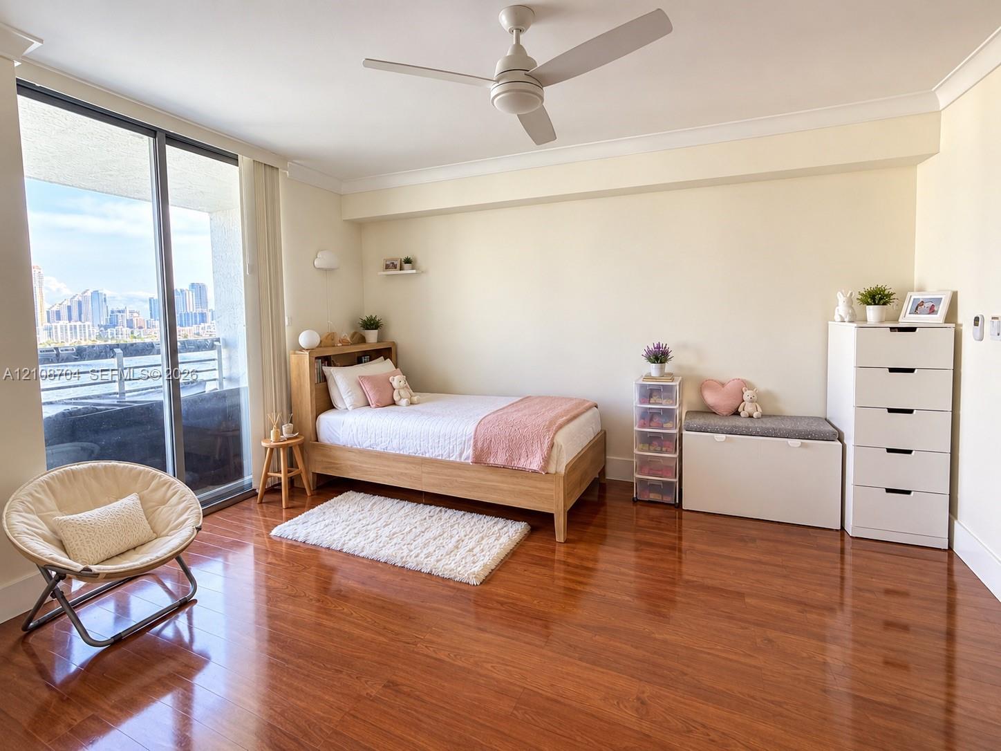 Hardwood flooring, ceiling fan with integrated lighting, and floor-to-ceiling sliding glass doors opening to an exterior balcony Hardwood flooring, ceiling fan with integrated lighting, and floor-to-ceiling sliding glass doors opening to an exterior balcony