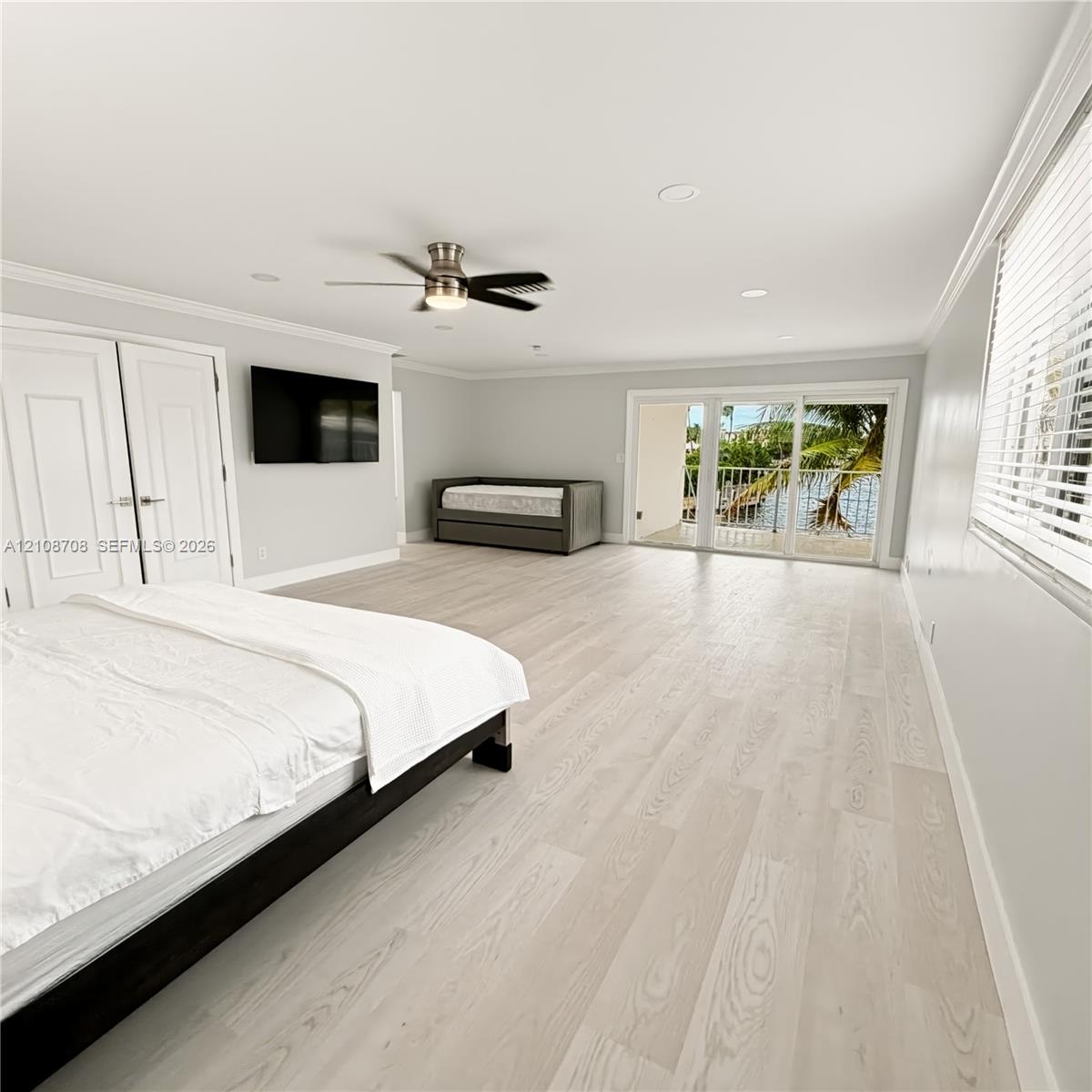 Primary bedroom with glass doors to the balcony
