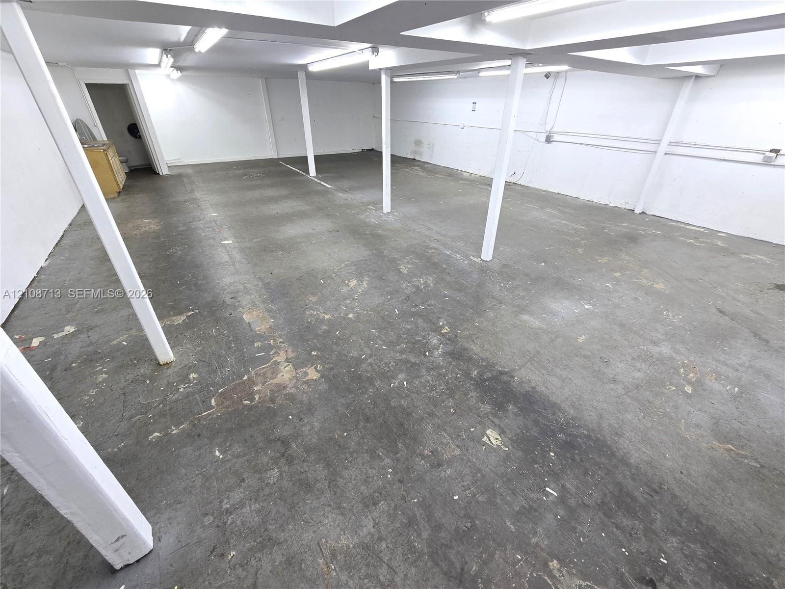 Open floor plan featuring concrete flooring, structural support columns, and recessed lighting