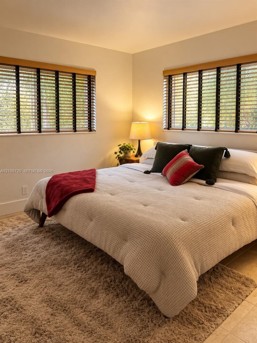 Neutral wall tones complemented by dual windows featuring wood-finish trim and horizontal window blinds Neutral wall tones complemented by dual windows featuring wood-finish trim and horizontal window blinds