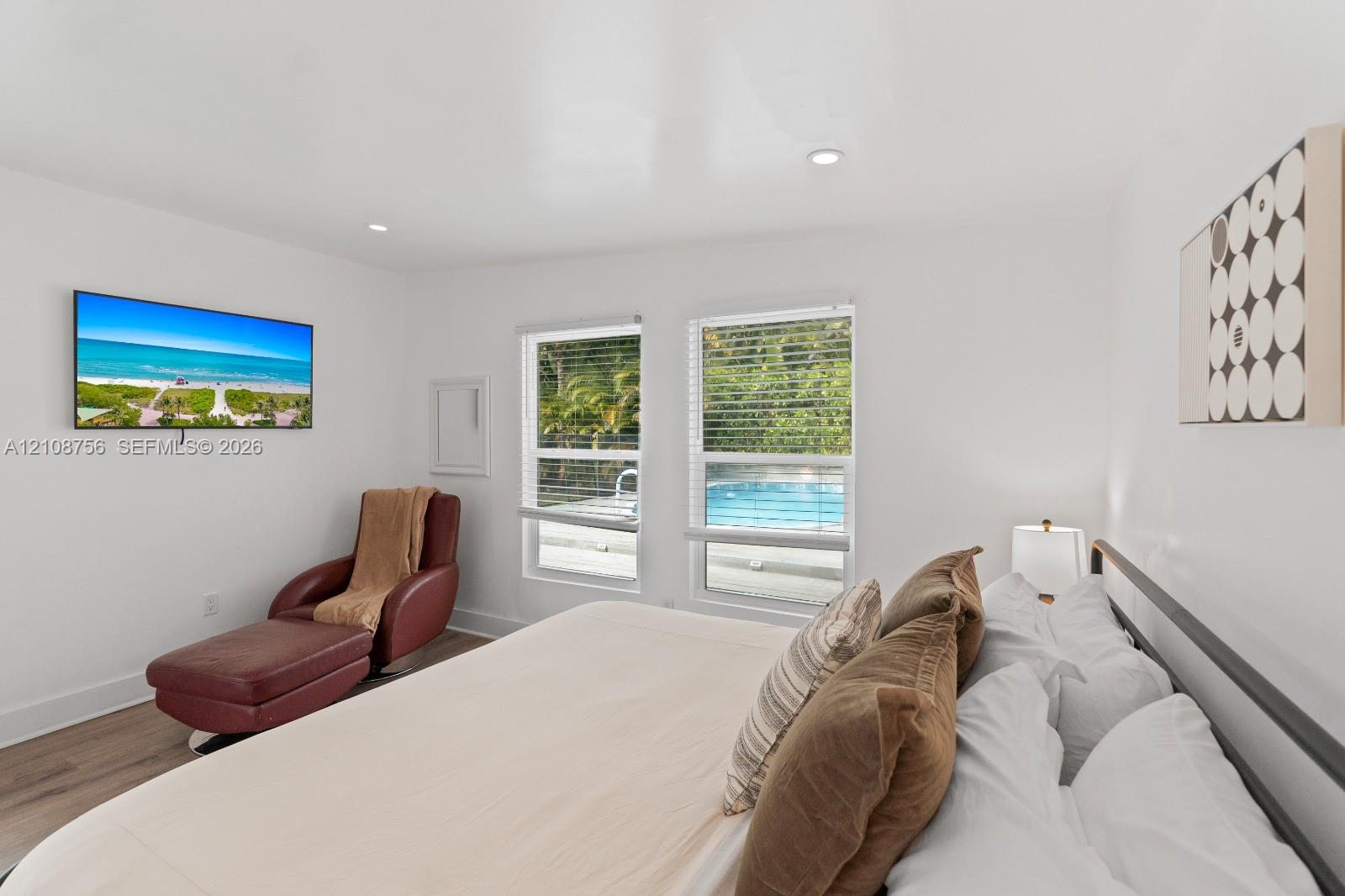 Interior space featuring wood-finish flooring, recessed lighting, and dual windows with window blinds