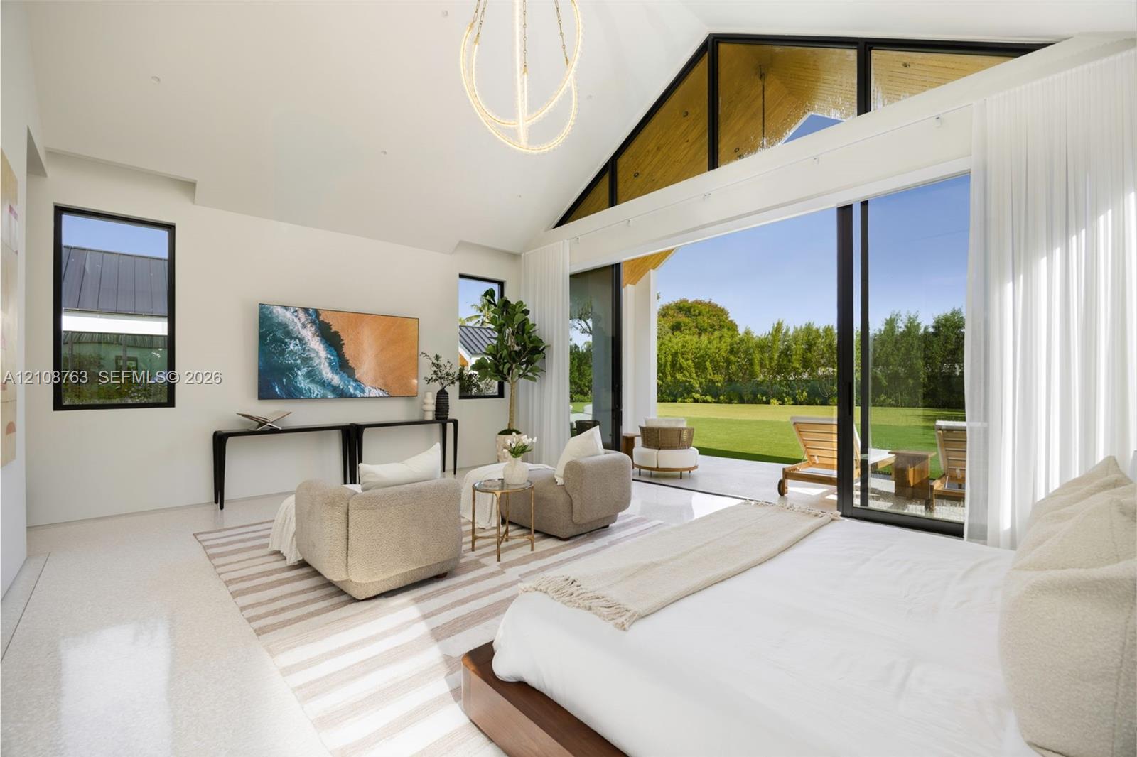 Vaulted ceilings with exposed timber detailing, expansive glass sliding walls, sleek polished flooring, and contemporary overhead lighting fixture
