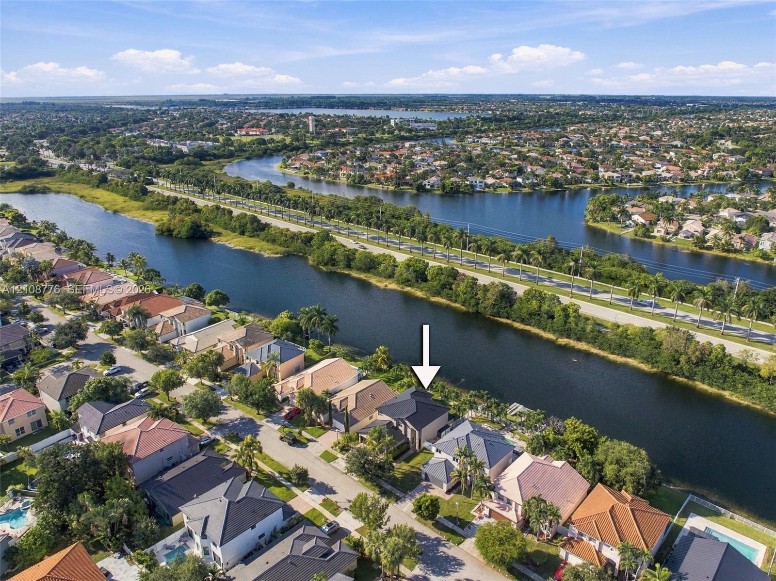 Waterfront property featuring a canal-side position, multi-level architectural design, and a shingled roof