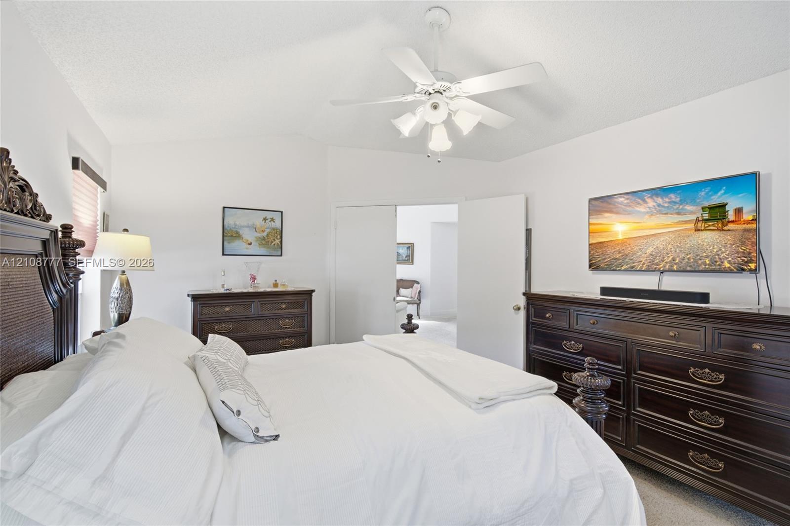 White vaulted ceilings featuring a central four-blade ceiling fan with integrated multi-light fixture
