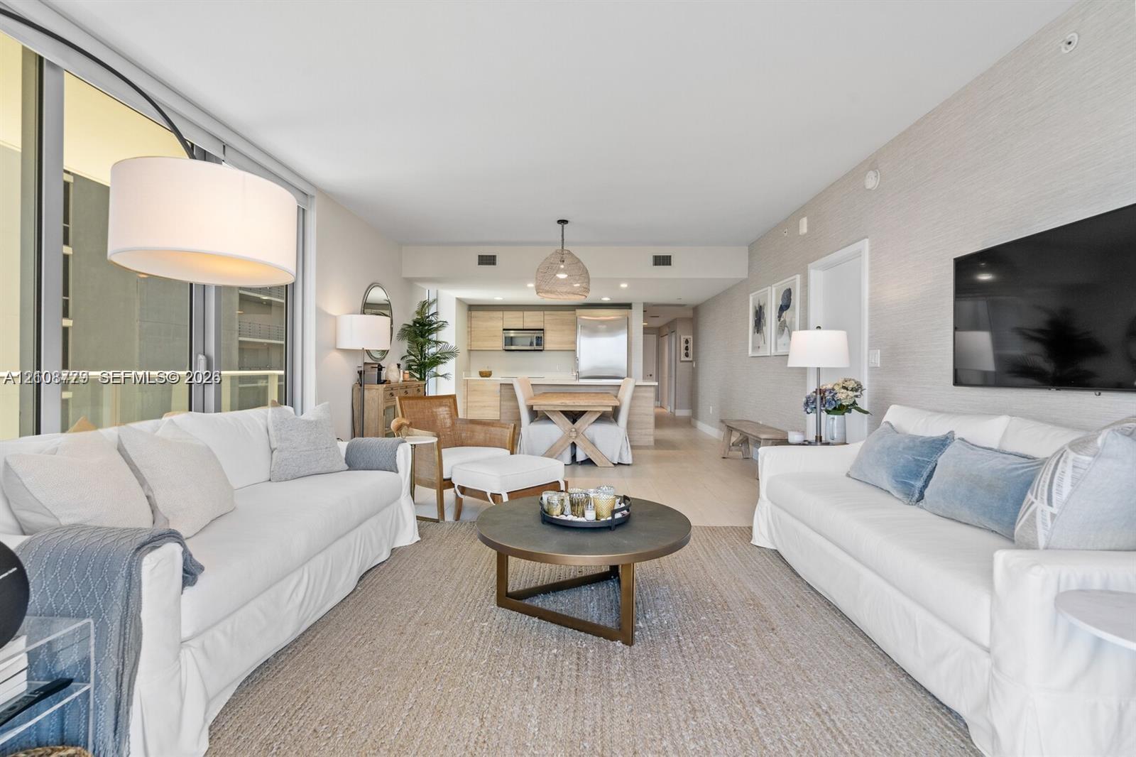 Floor-to-ceiling glass sliding doors, textured wall treatments, wood-finish flooring, and integrated kitchen cabinetry Floor-to-ceiling glass sliding doors, textured wall treatments, wood-finish flooring, and integrated kitchen cabinetry