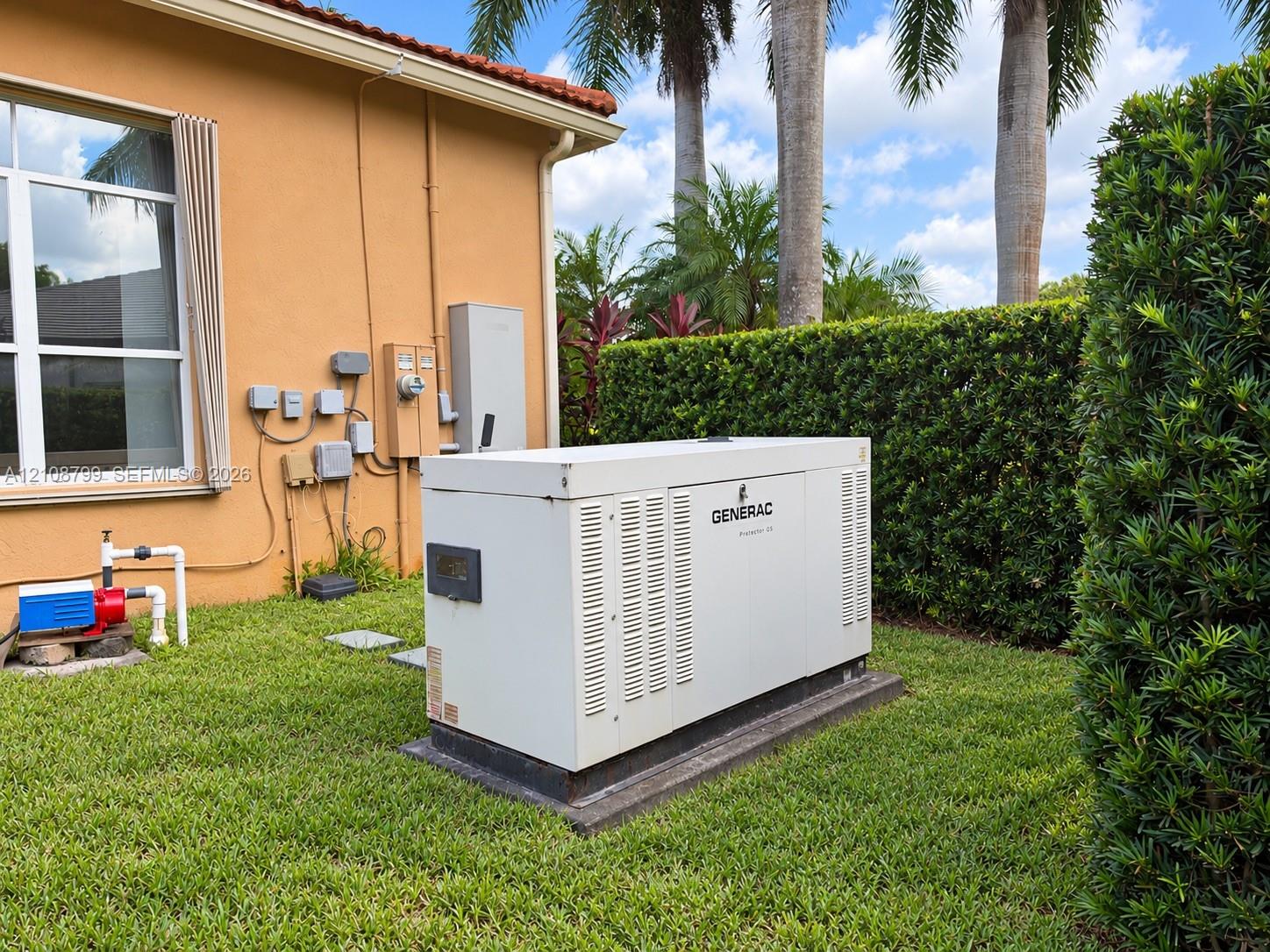 Whole-house standby generator situated on a concrete pad within the side yard - 1000 gallons