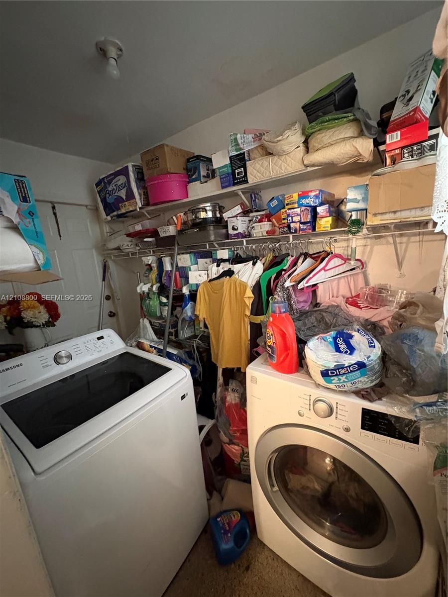 Laundry area featuring tiered wire shelving and a white interior door
