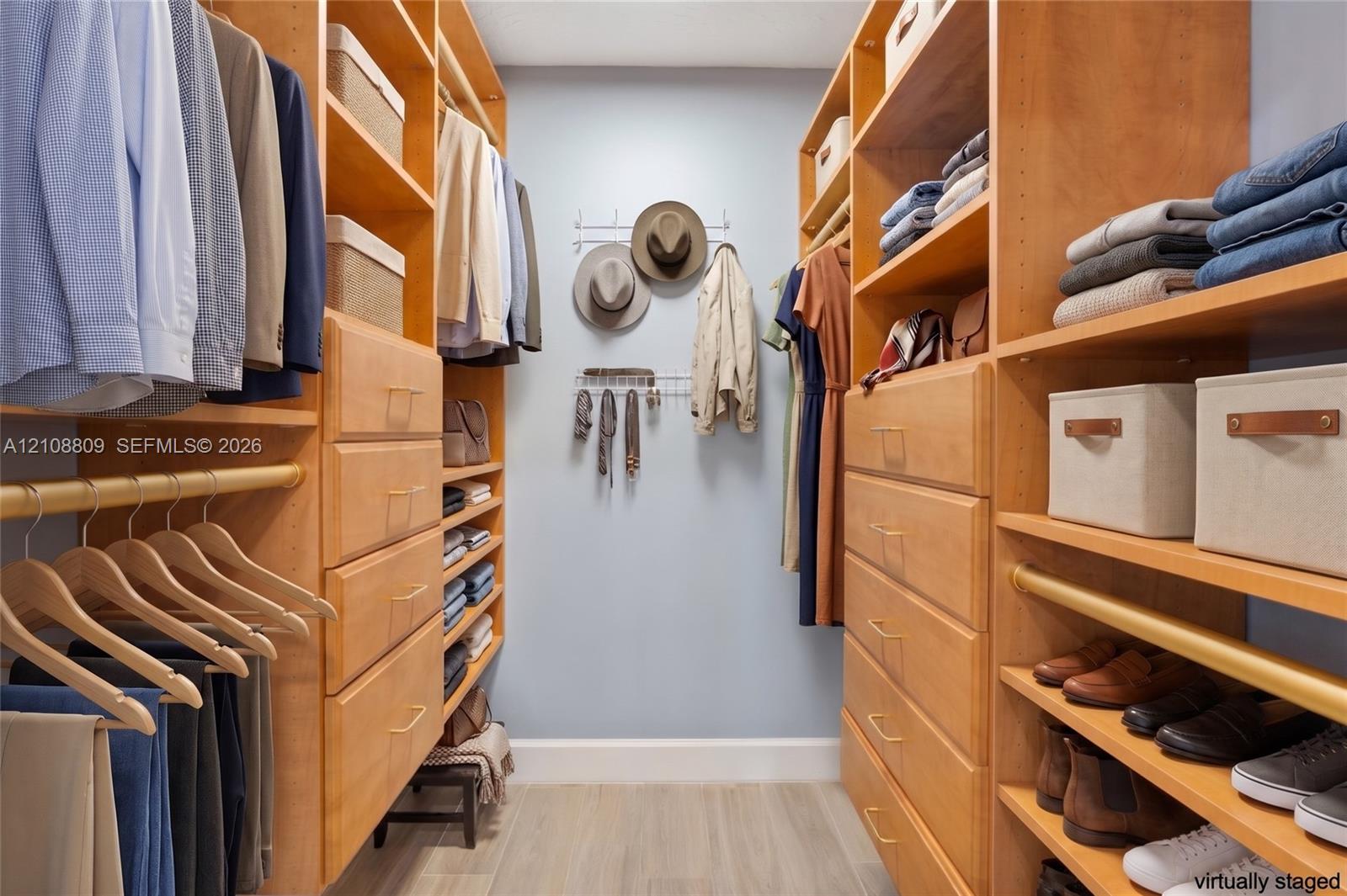 Custom walk-in closet featuring floor-to-ceiling wooden shelving, integrated dresser drawers, multi-level hanging rods, and open shoe storage