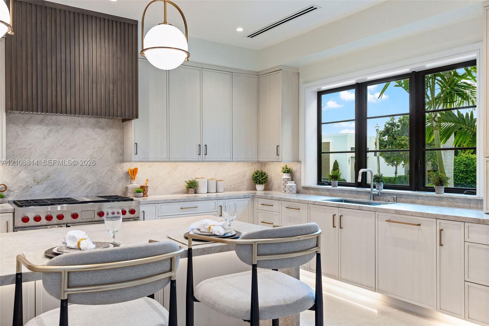 Kitchen featuring flat-panel cabinetry, a stone-surfaced island and countertops, a custom slatted wood range hood, a professional-style gas range, and large-format windows with black frames