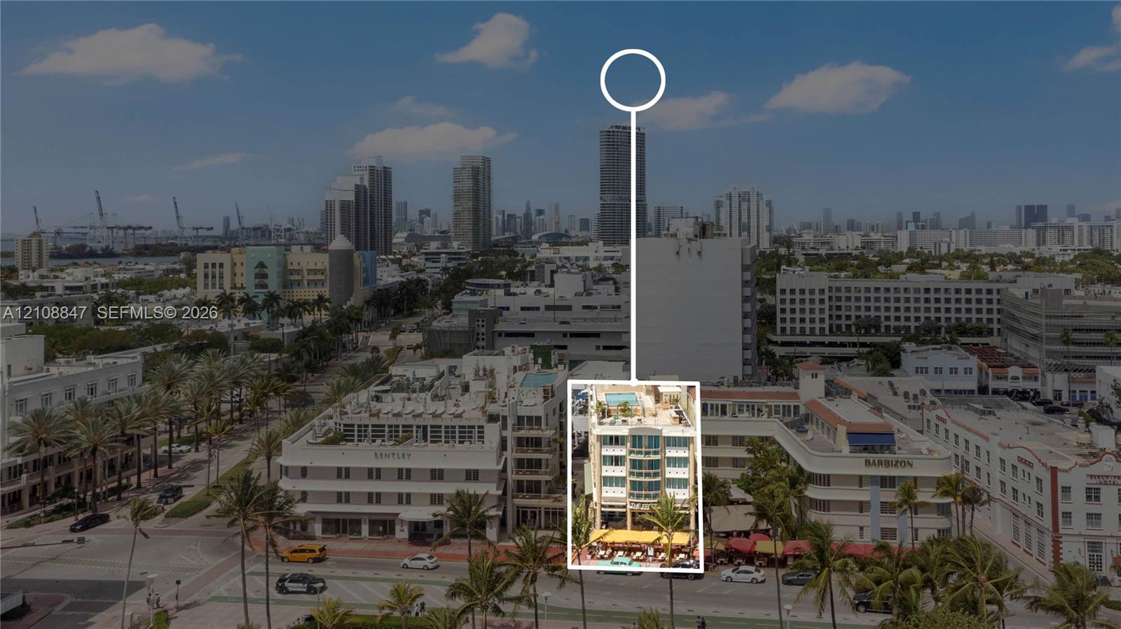 Aerial perspective featuring a multi-story building with a rooftop pool deck and prominent glass-facade balconies