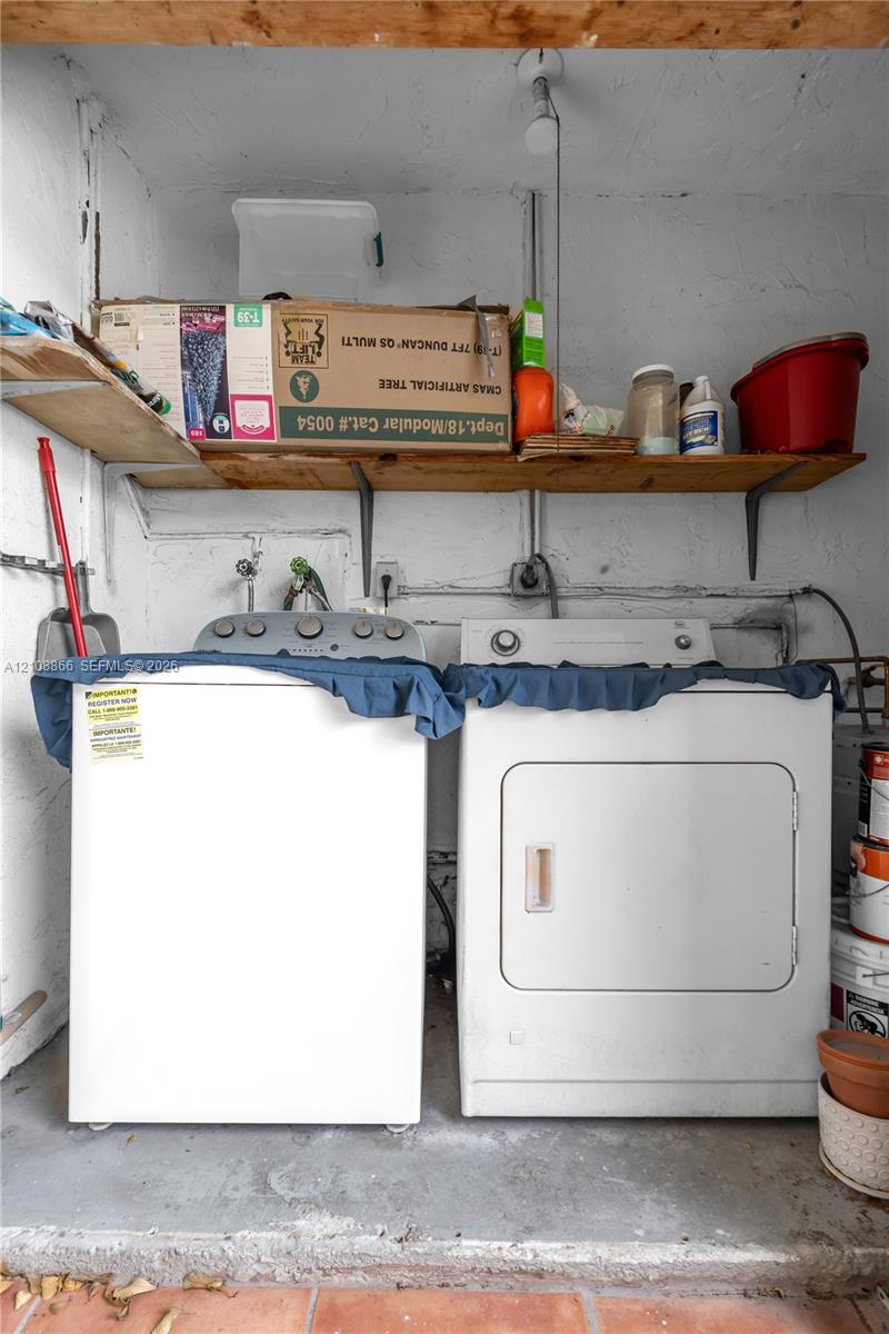 Laundry area featuring wall-mounted wooden shelving and concrete flooring