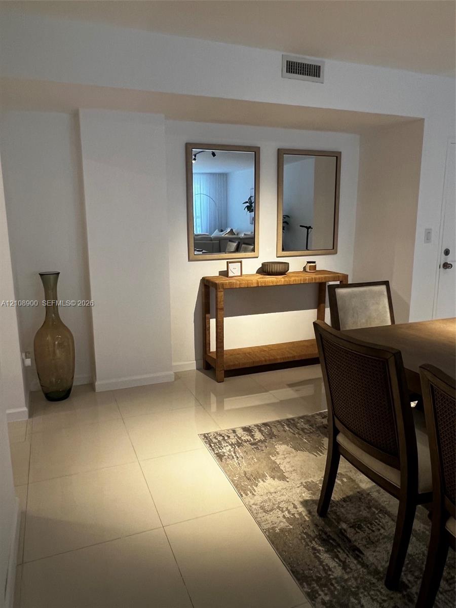 Large-format tile flooring complemented by recessed wall mirrors and smooth finish wall surfaces