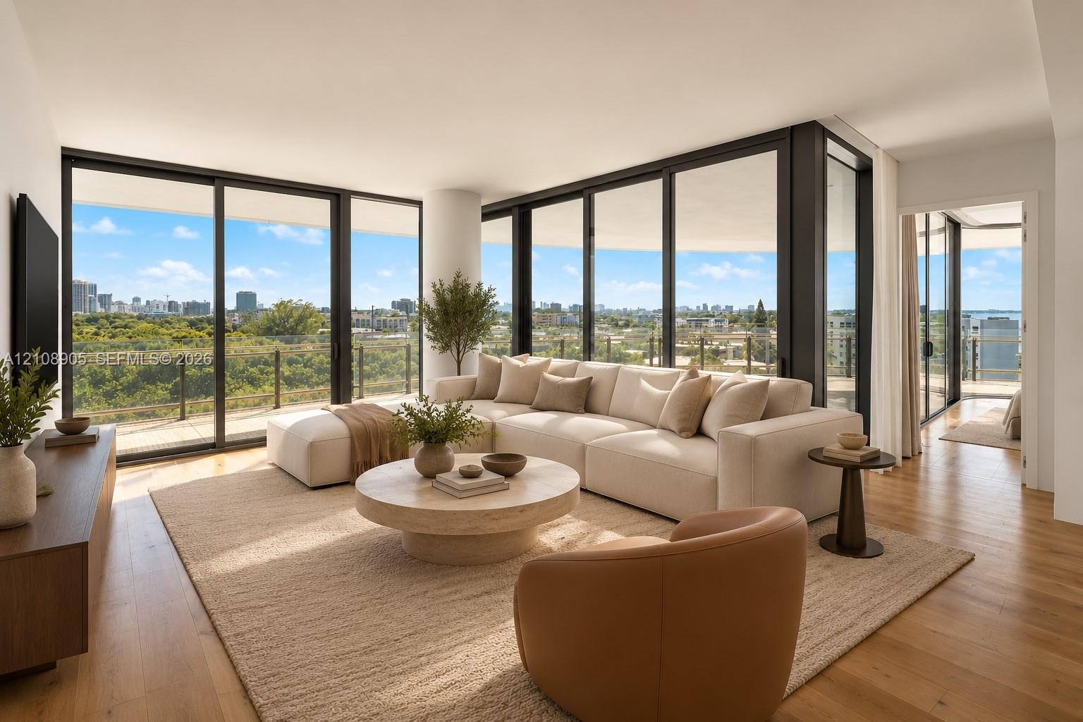 Floor-to-ceiling sliding glass walls, expansive wraparound balcony with glass railing, wood-finish flooring, and recessed ceiling lighting Floor-to-ceiling sliding glass walls, expansive wraparound balcony with glass railing, wood-finish flooring, and recessed ceiling lighting