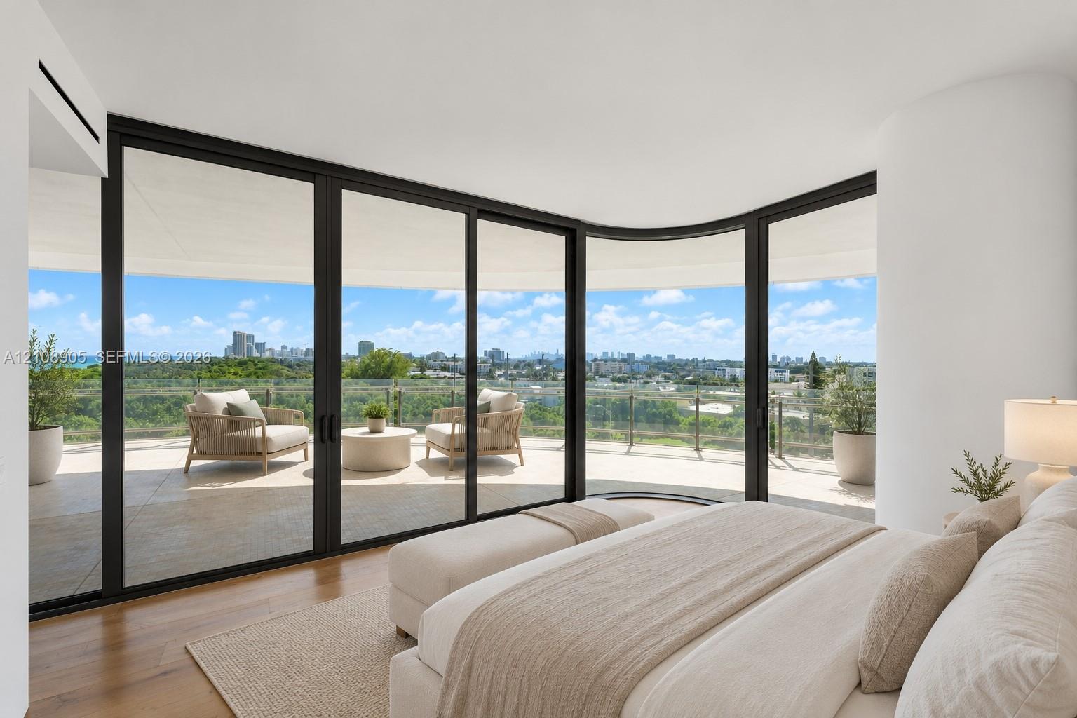 Curved floor-to-ceiling glass walls with black frames, wood-finish flooring, and a expansive wrap-around balcony featuring a glass railing