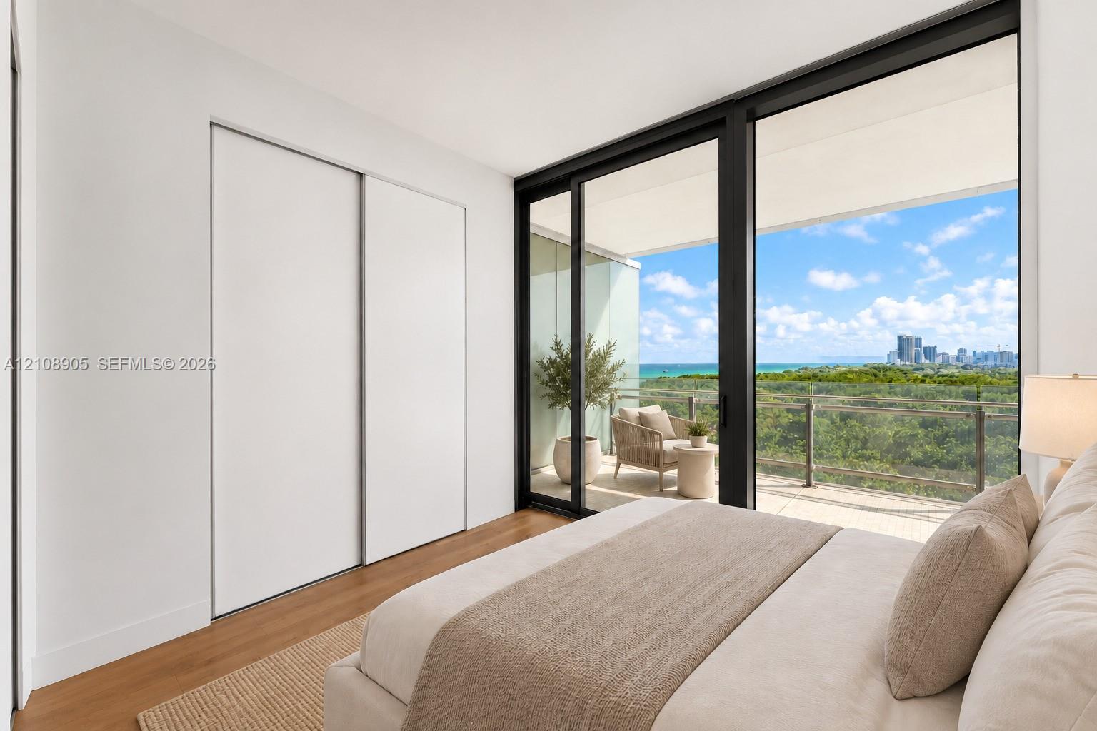 Floor-to-ceiling sliding glass doors, private covered balcony, wood-finish flooring, and built-in sliding door closet