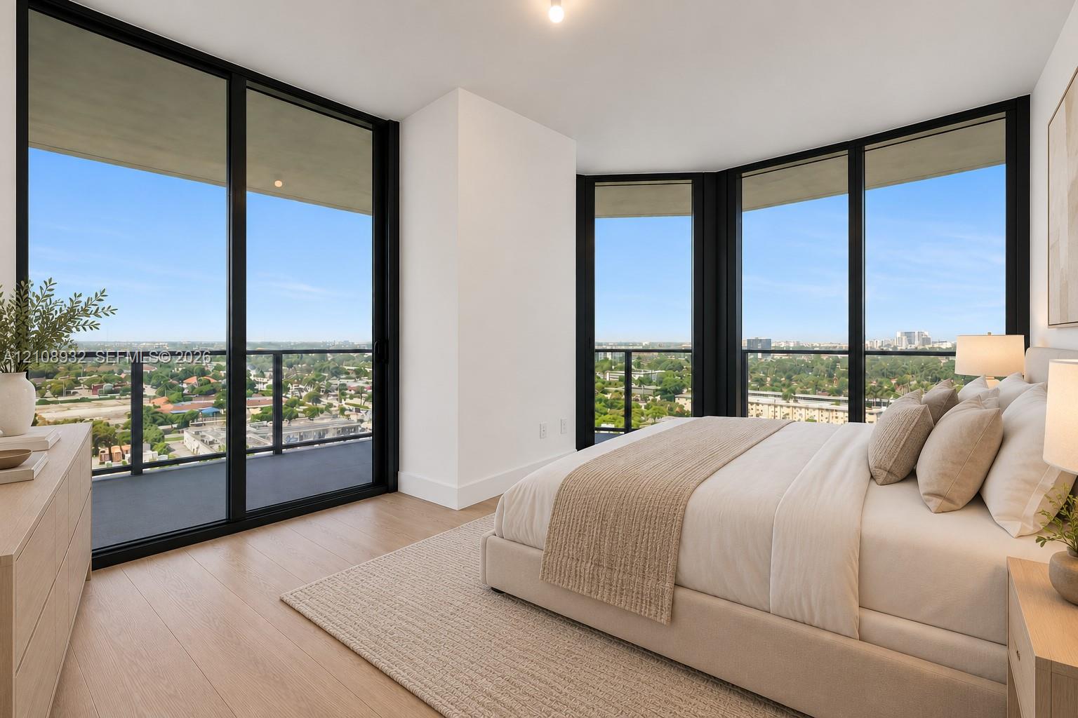 Floor-to-ceiling windows, wood-finish flooring, and an expansive wraparound balcony with metal railings