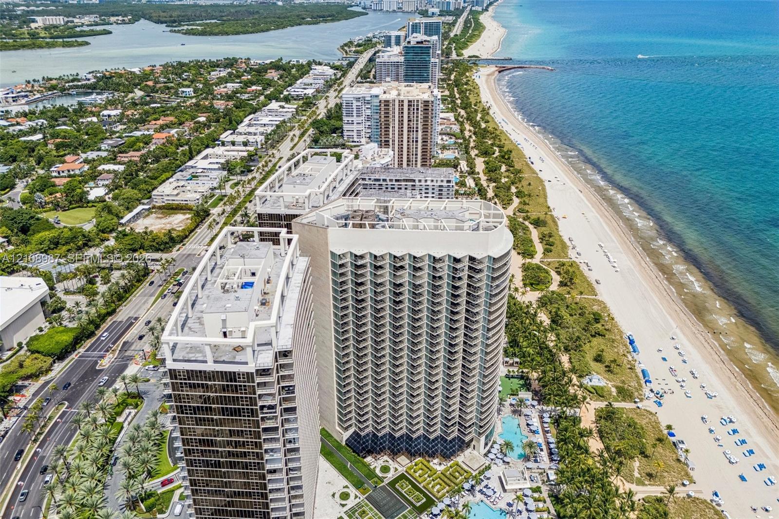 High-rise coastal towers featuring private balconies, integrated swimming pools, geometric architectural facades, and direct proximity to the oceanfront