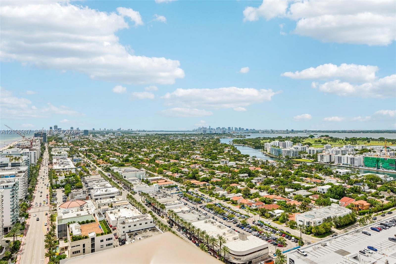 Aerial perspective of the urban landscape featuring the coastline, waterways, and metropolitan skyline