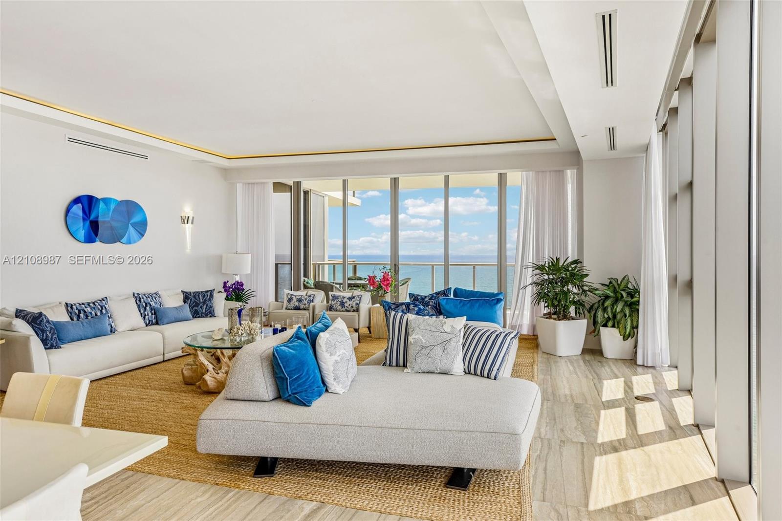 Floor-to-ceiling glass panel walls, natural stone flooring, recessed perimeter ceiling lighting, and expansive balcony access Floor-to-ceiling glass panel walls, natural stone flooring, recessed perimeter ceiling lighting, and expansive balcony access