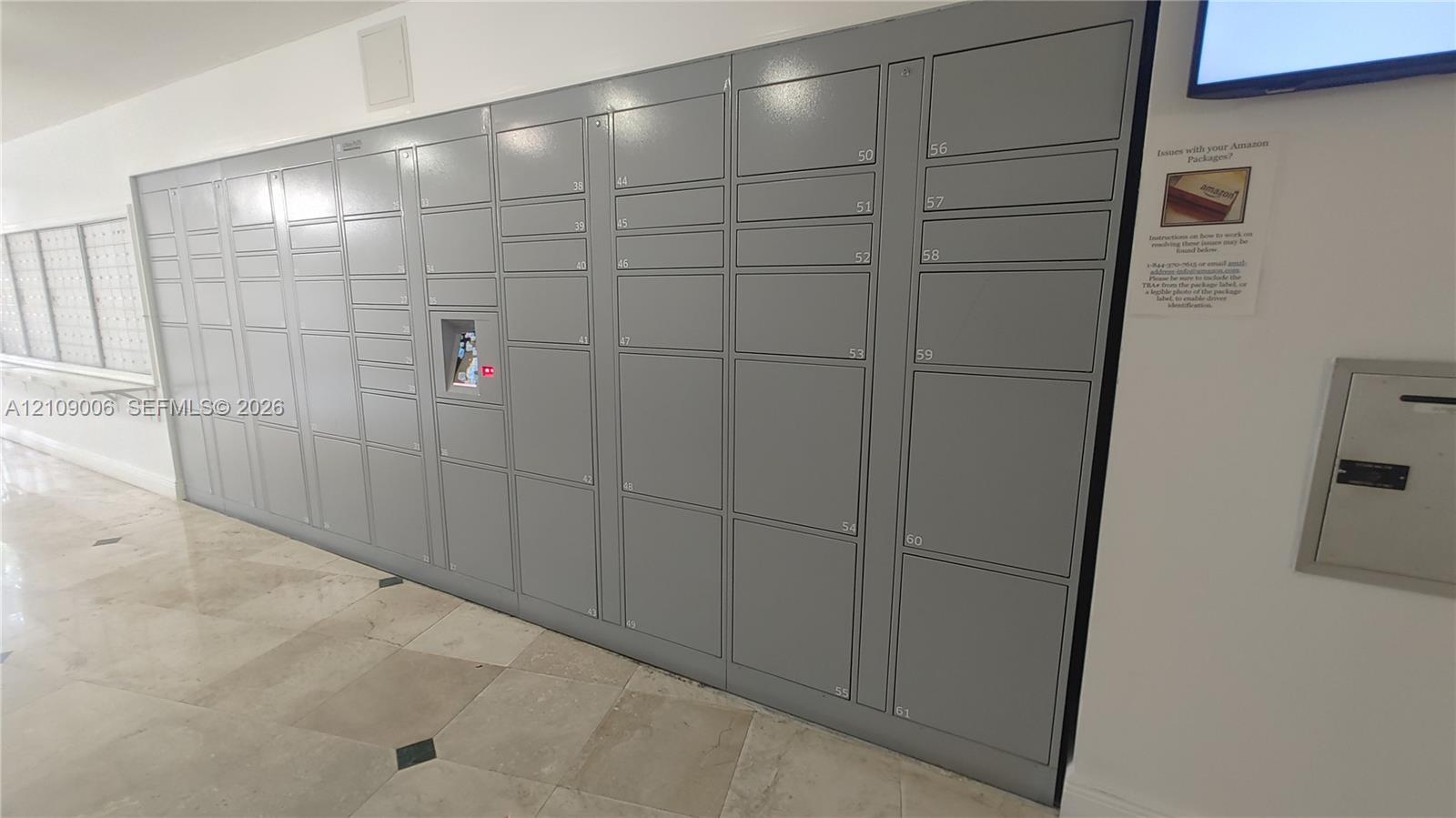 Automated package locker system featuring varying compartment sizes, a centralized digital interface, and a metallic gray finish