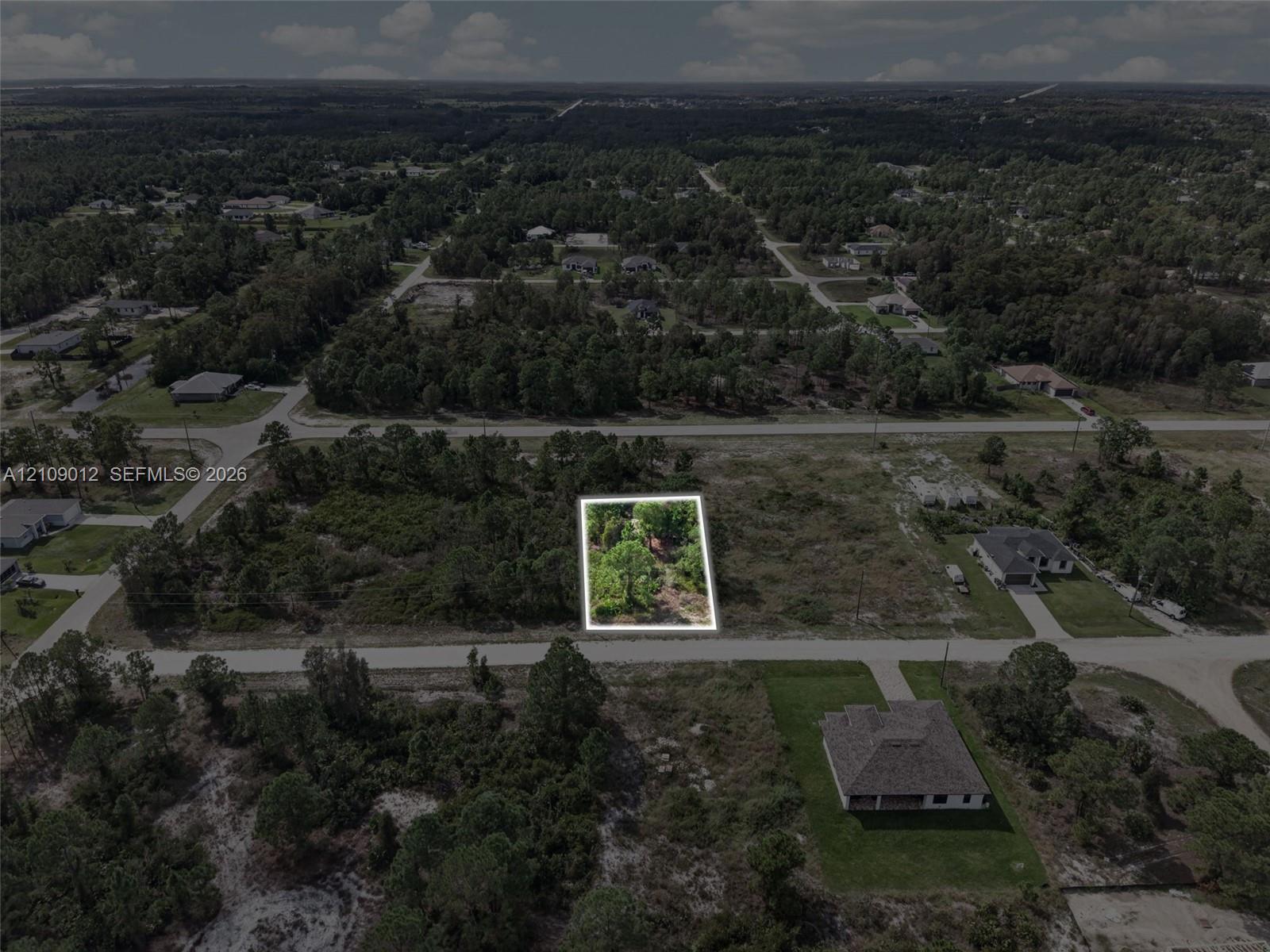Vacant parcel of land featuring native vegetation and direct road access
