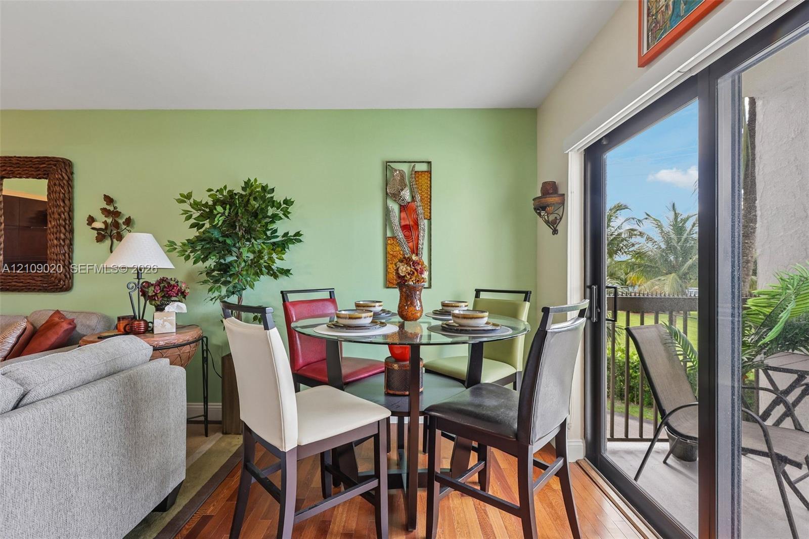 Wood-finish flooring and floor-to-ceiling sliding glass doors opening to a balcony