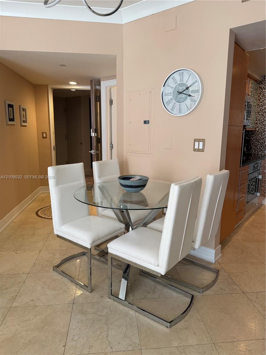 Stone-tile flooring throughout, recessed ceiling lighting, and crown molding