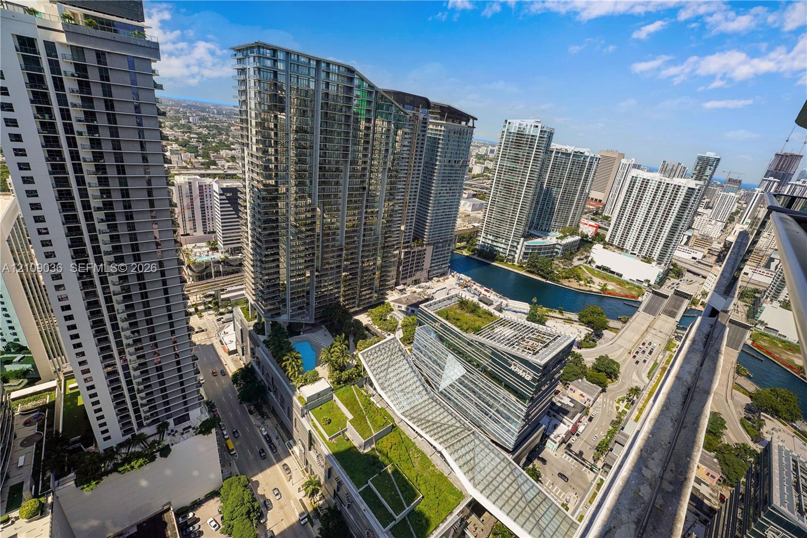 High-rise perspective featuring an outdoor swimming pool, landscaped green roofs, glass-facade architecture, and water frontage High-rise perspective featuring an outdoor swimming pool, landscaped green roofs, glass-facade architecture, and water frontage