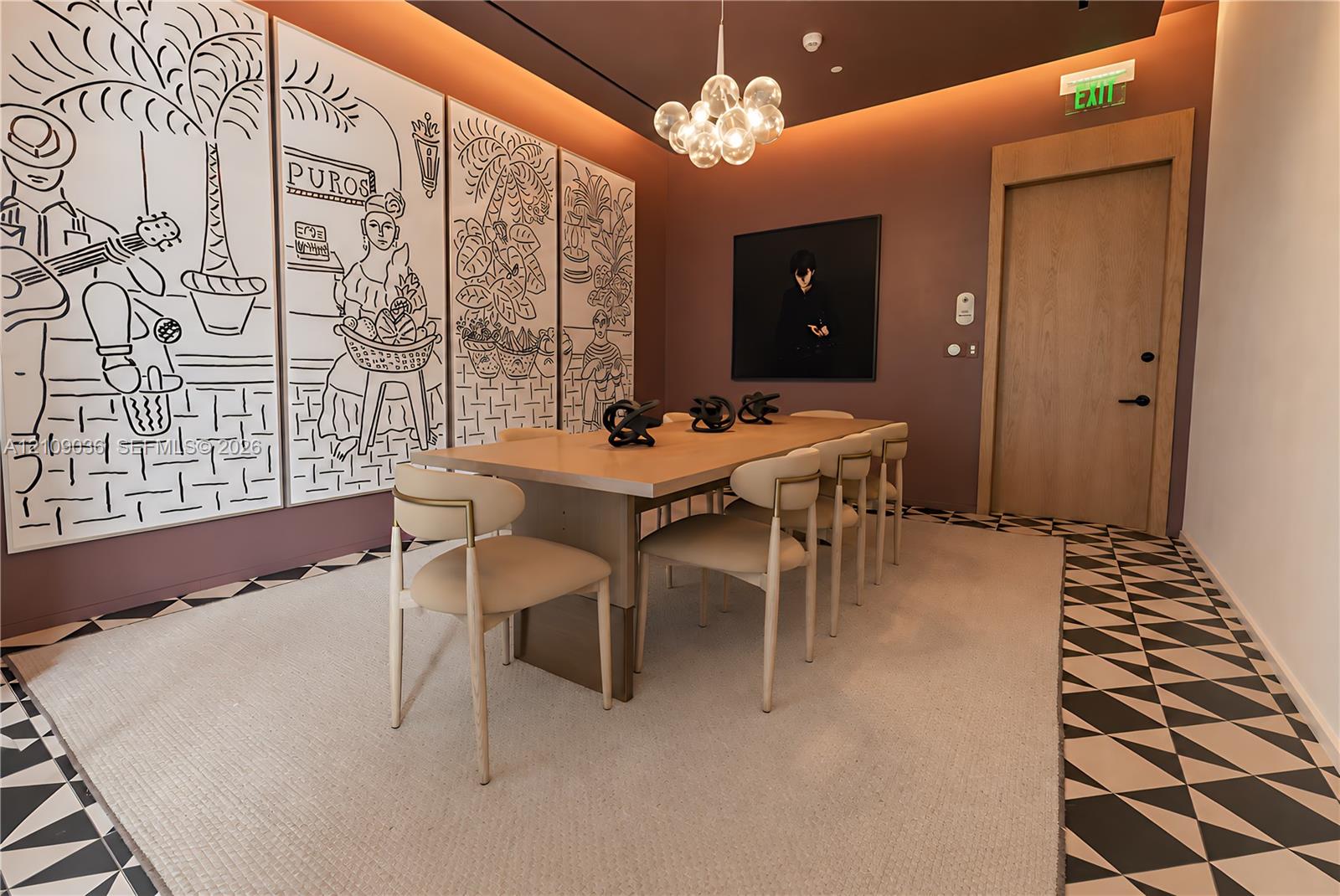 Geometric patterned flooring, recessed cove lighting, suspended multi-globe chandelier, and wood-finish door with matching frame