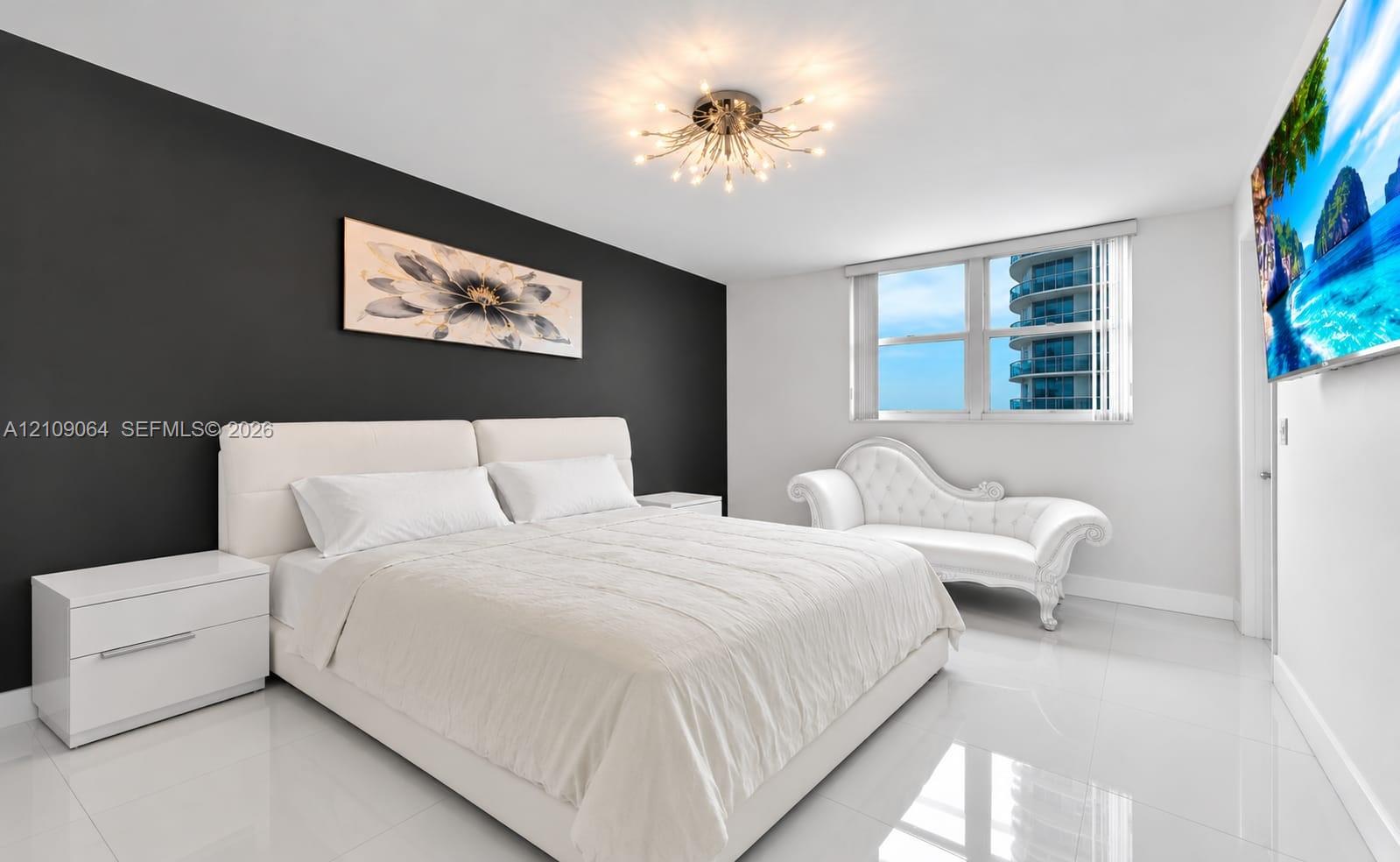 Room featuring high-gloss tile flooring, a charcoal-toned accent wall, and a multi-arm sputnik-style flush mount ceiling light
