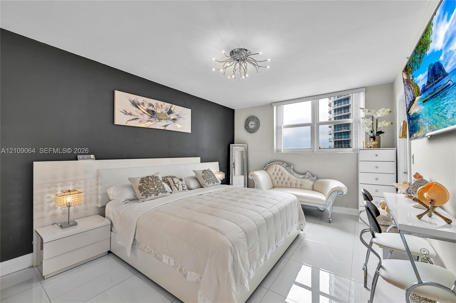 Space featuring a contrasting charcoal accent wall, high-gloss tile flooring, multi-light flush mount ceiling fixture, and a built-in white laminate headboard
