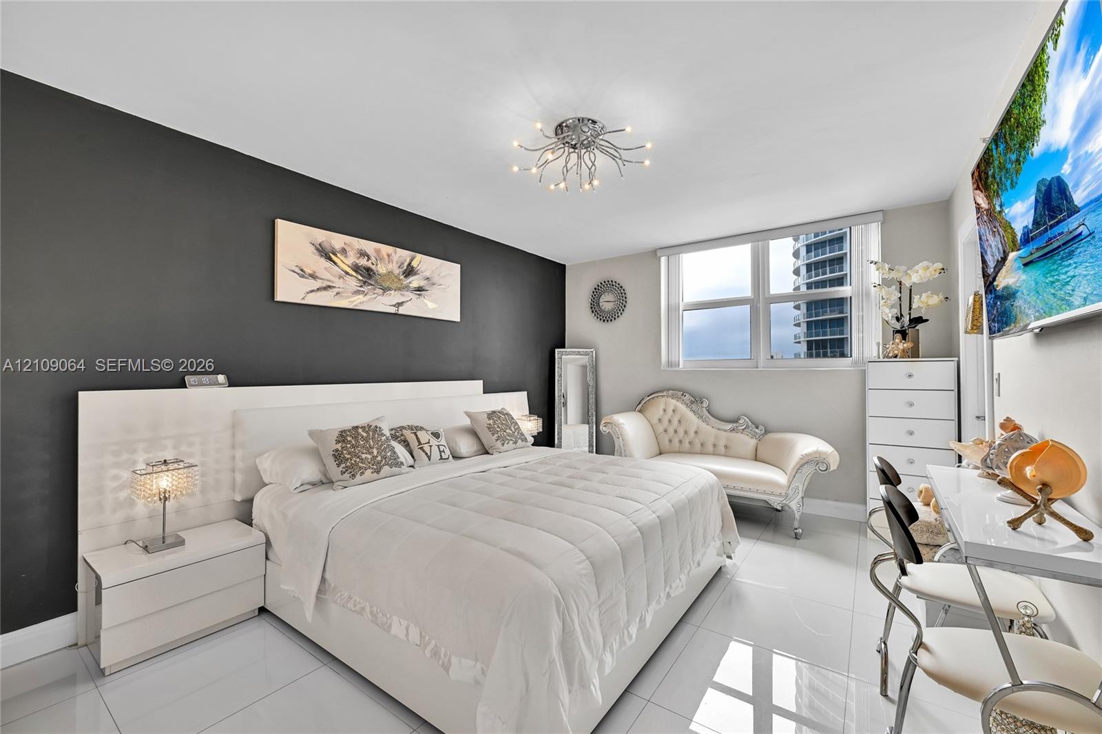 High-gloss tile flooring, charcoal accent wall, integrated white headboard with built-in side tables, and modern multi-bulb flush-mount ceiling lighting