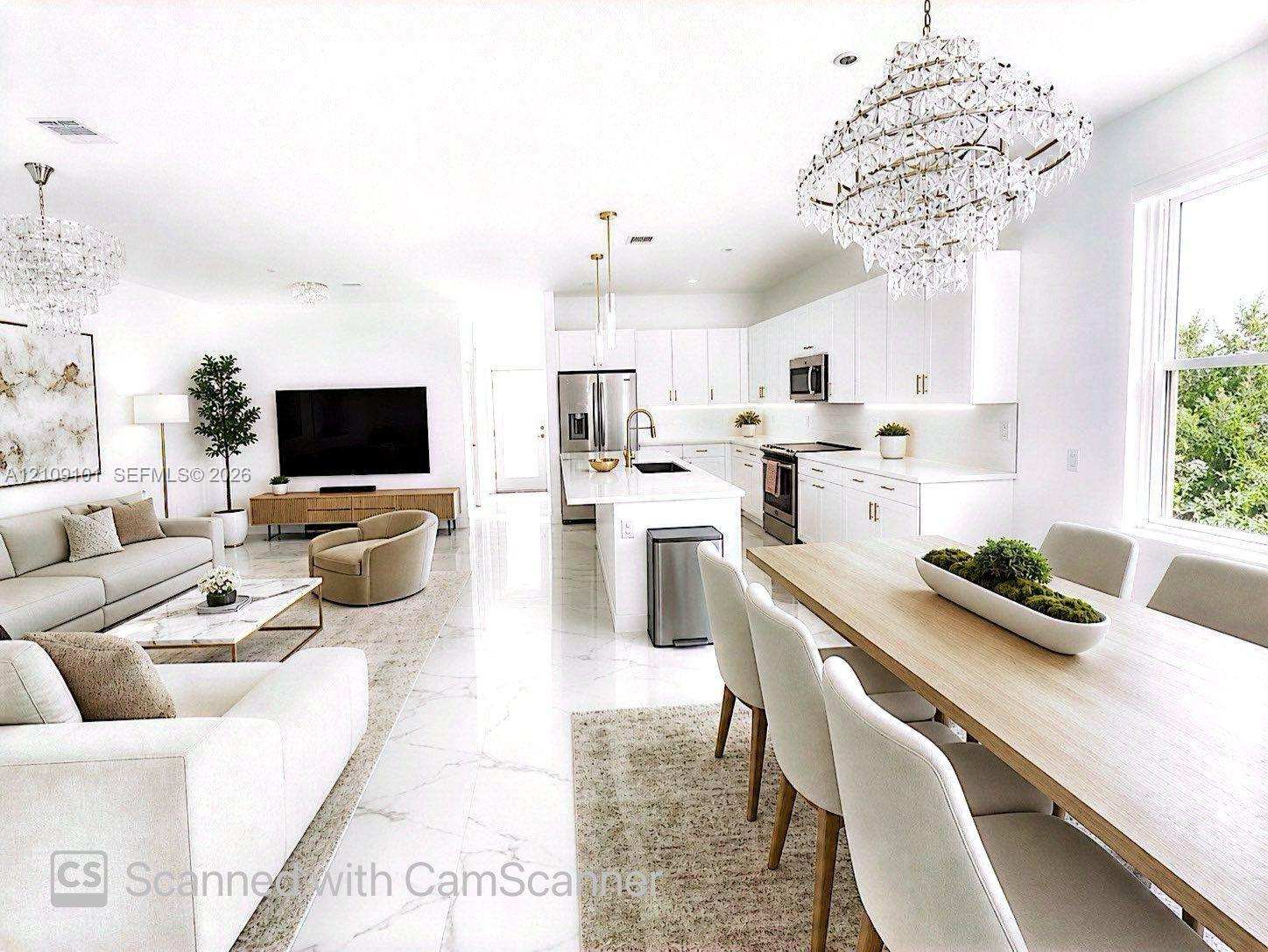 Open-concept living space featuring high-gloss large-format floor tile, white cabinetry with integrated under-cabinet lighting, a central kitchen island with a quartz countertop, and oversized crystal-style chandelier lighting fixtures Open-concept living space featuring high-gloss large-format floor tile, white cabinetry with integrated under-cabinet lighting, a central kitchen island with a quartz countertop, and oversized crystal-style chandelier lighting fixtures