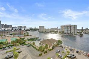 High-rise perspective featuring panoramic water frontage, palm landscaping, and urban skyline horizon High-rise perspective featuring panoramic water frontage, palm landscaping, and urban skyline horizon