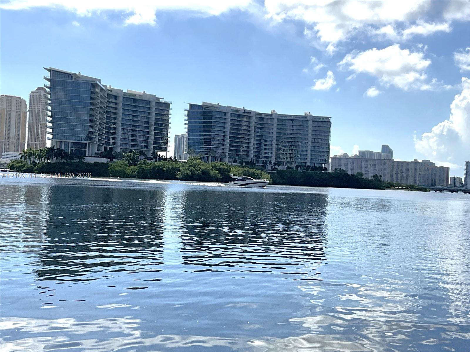 Waterfront location featuring expansive coastal horizons and multi-story high-rise structures