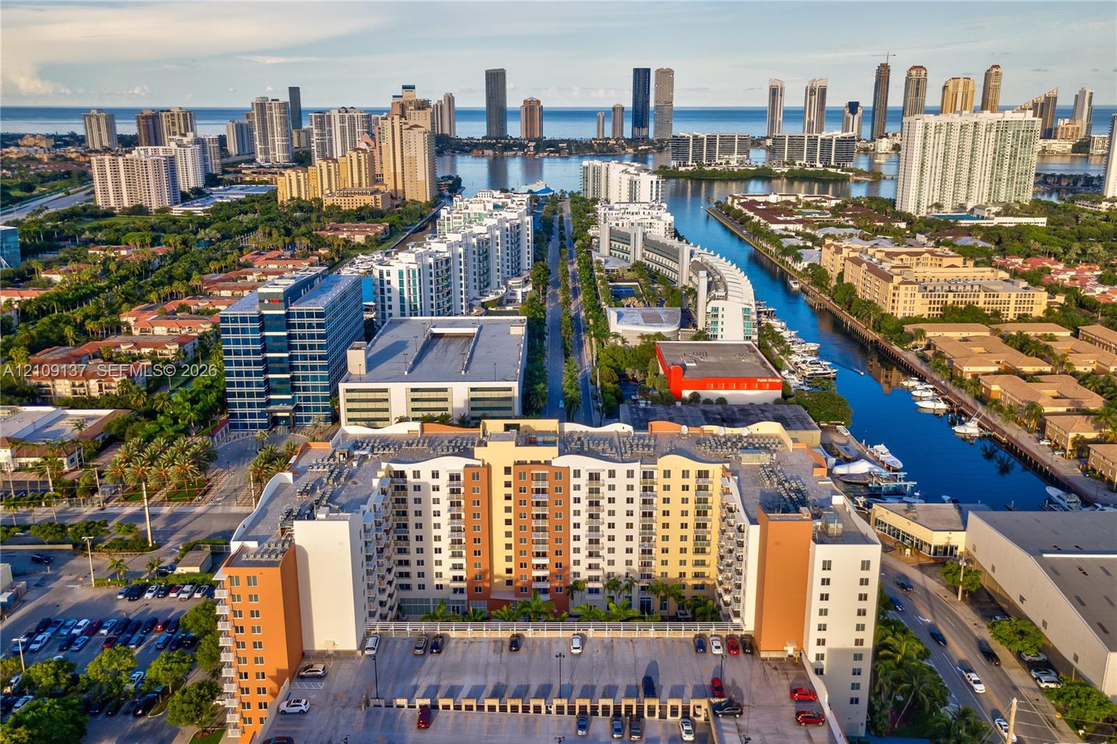 Multi-story high-rise building featuring a structured parking facility, concrete facade, and integrated balconies Multi-story high-rise building featuring a structured parking facility, concrete facade, and integrated balconies