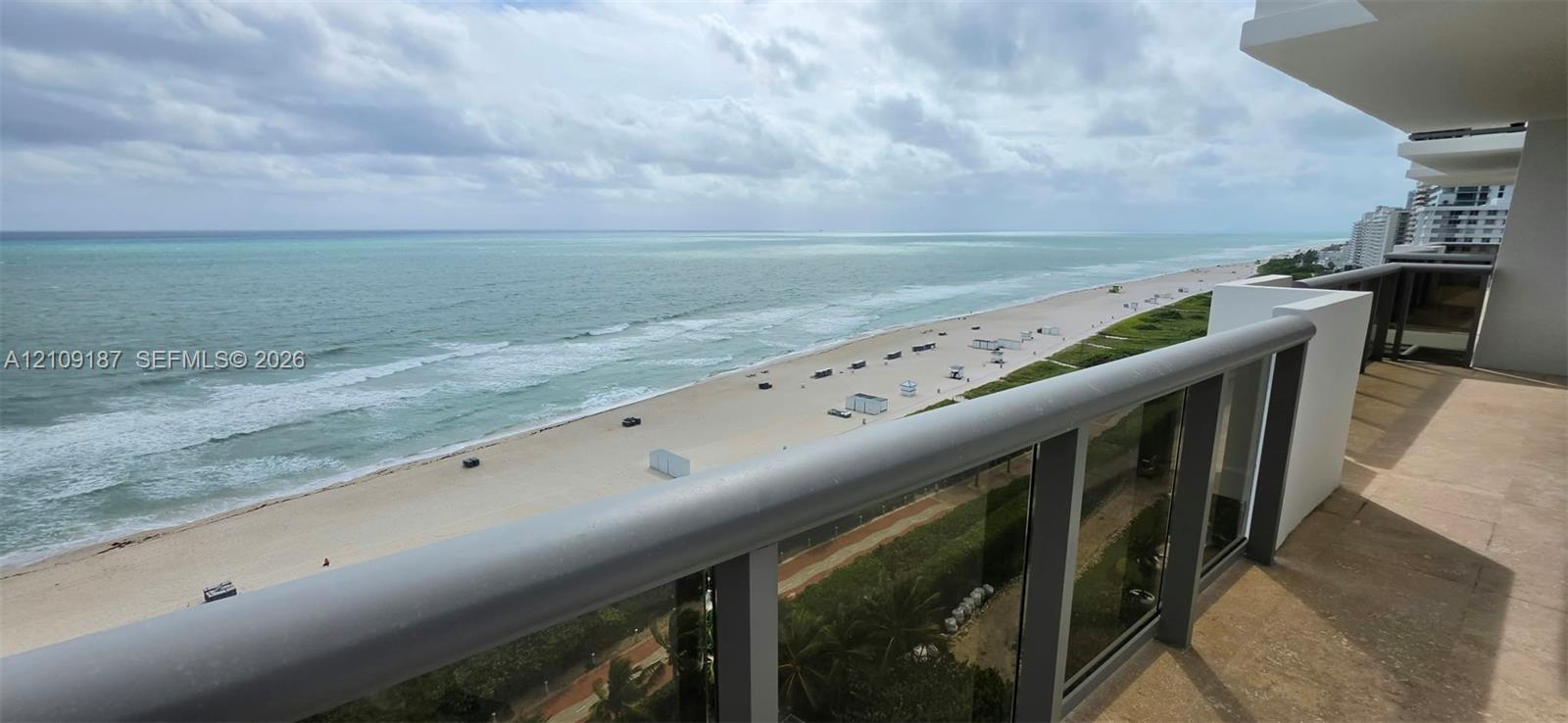 Private balcony with marble flooring and a glass-paneled railing overlooking the coastline and direct front 180 ocean view. Private balcony with marble flooring and a glass-paneled railing overlooking the coastline and direct front 180 ocean view.