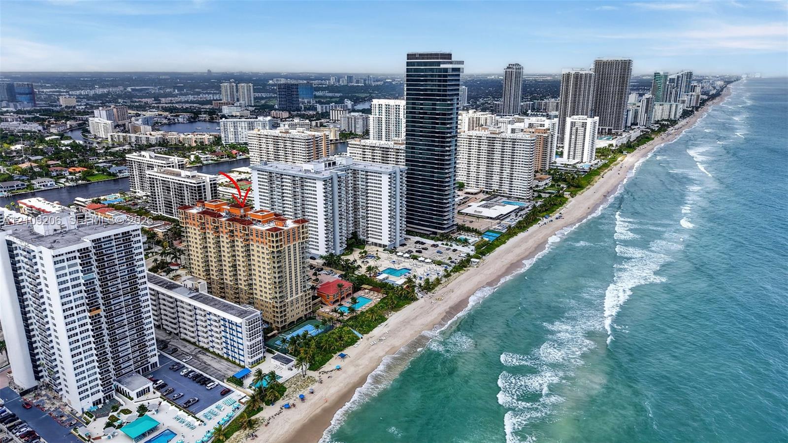 Aerial perspective featuring a high-rise residential building situated on the Atlantic coastline