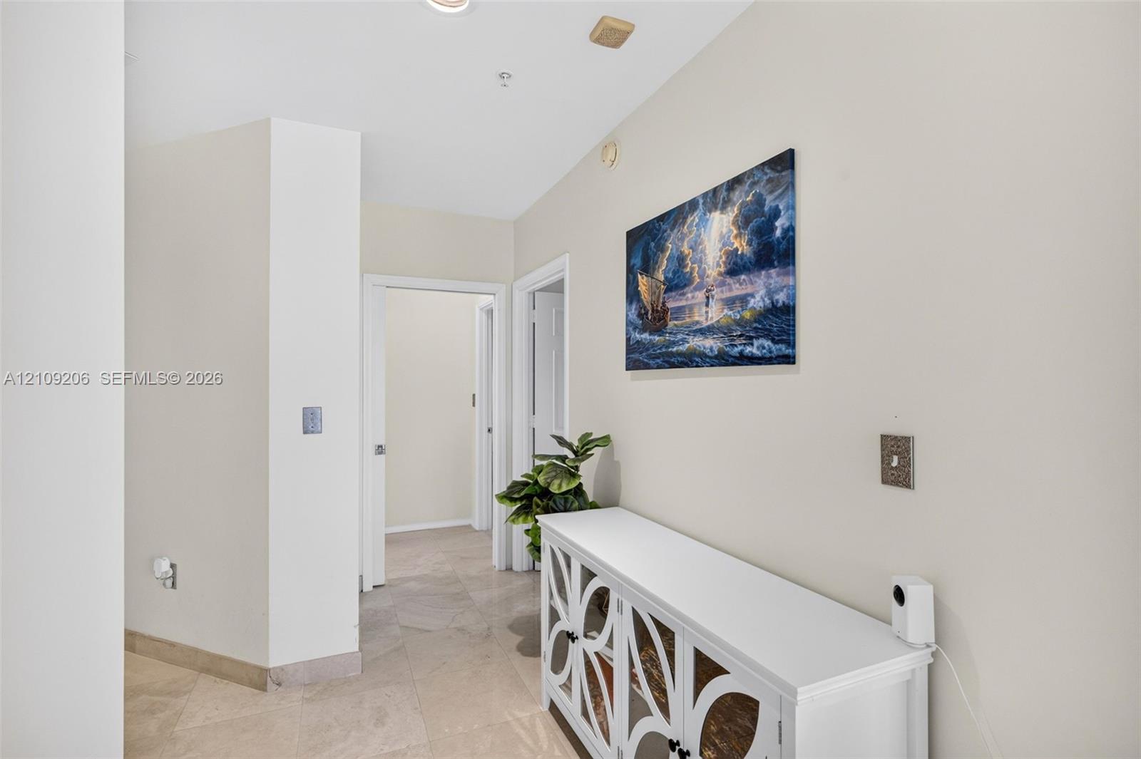 Neutral-toned interior hall featuring stone-tile flooring and recessed ceiling lighting