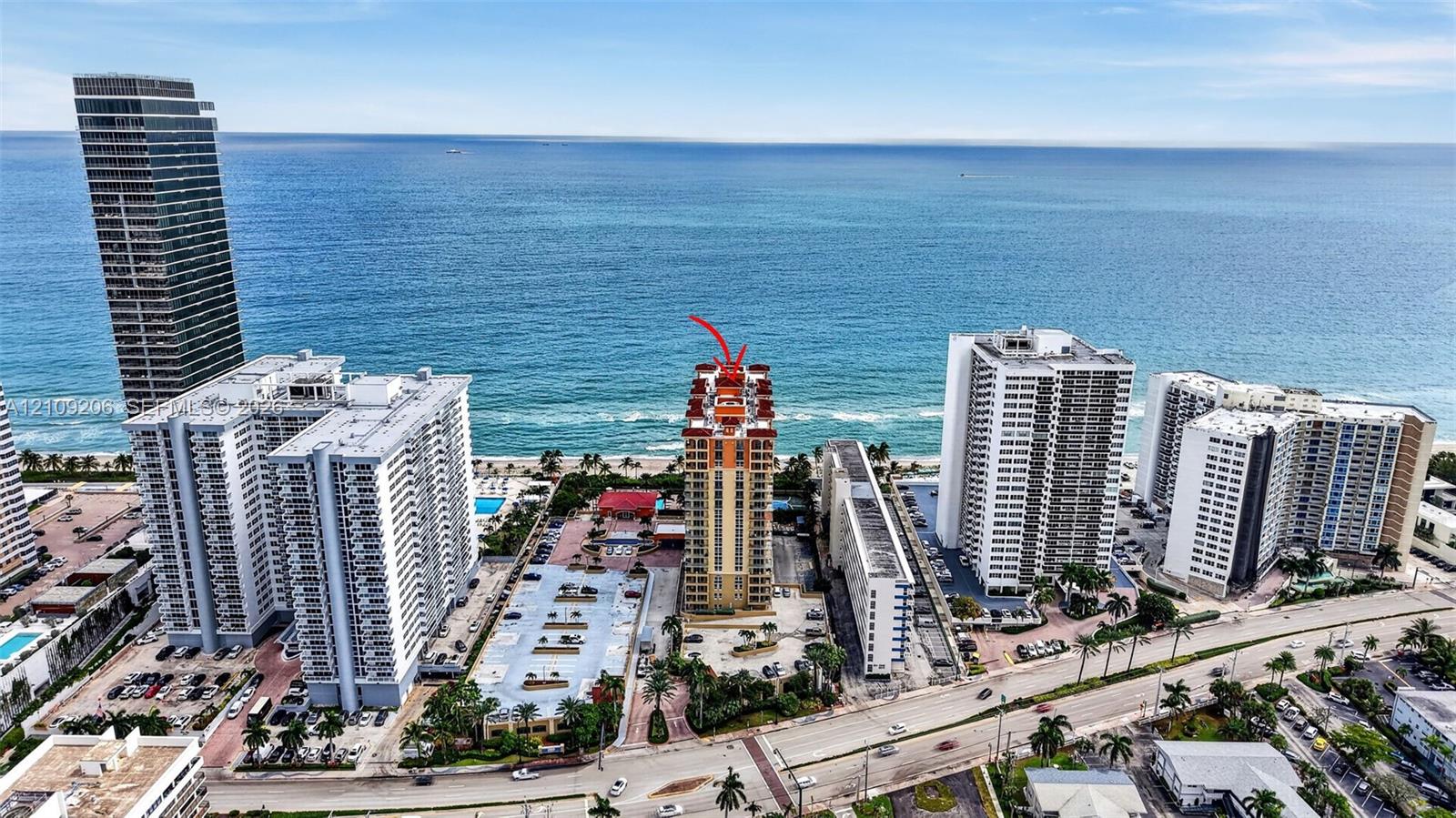 High-rise coastal property featuring direct ocean proximity and a multi-level structure with an expansive footprint